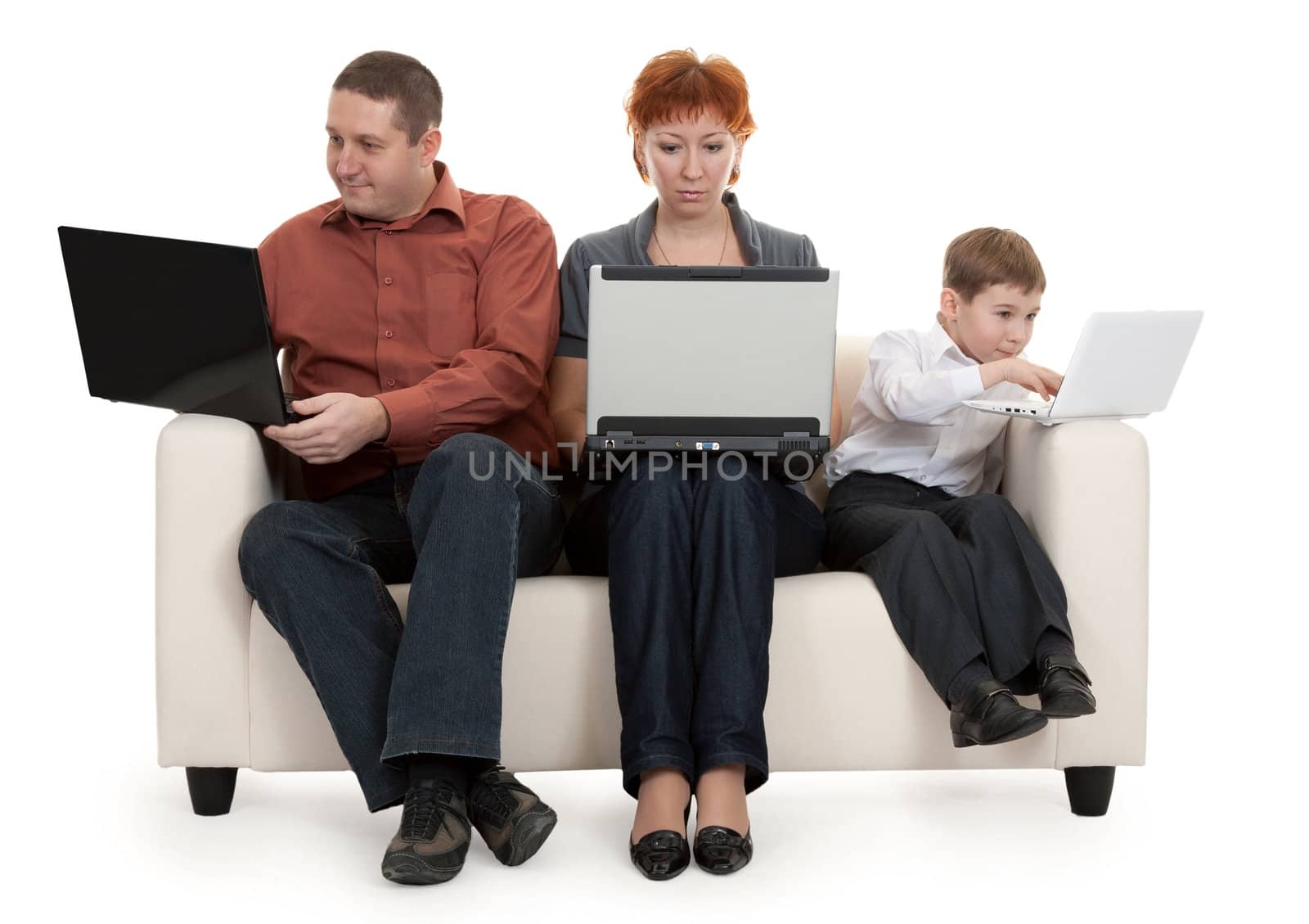 dad mom and son with laptop sitting on the couch