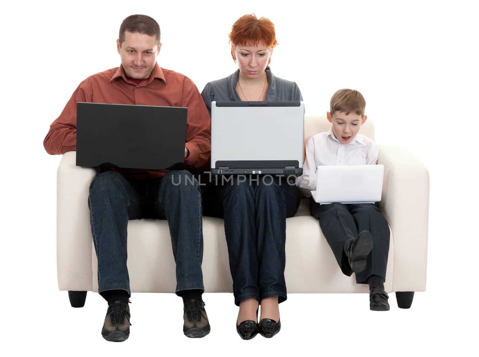dad mom and son with laptop sitting on the couch