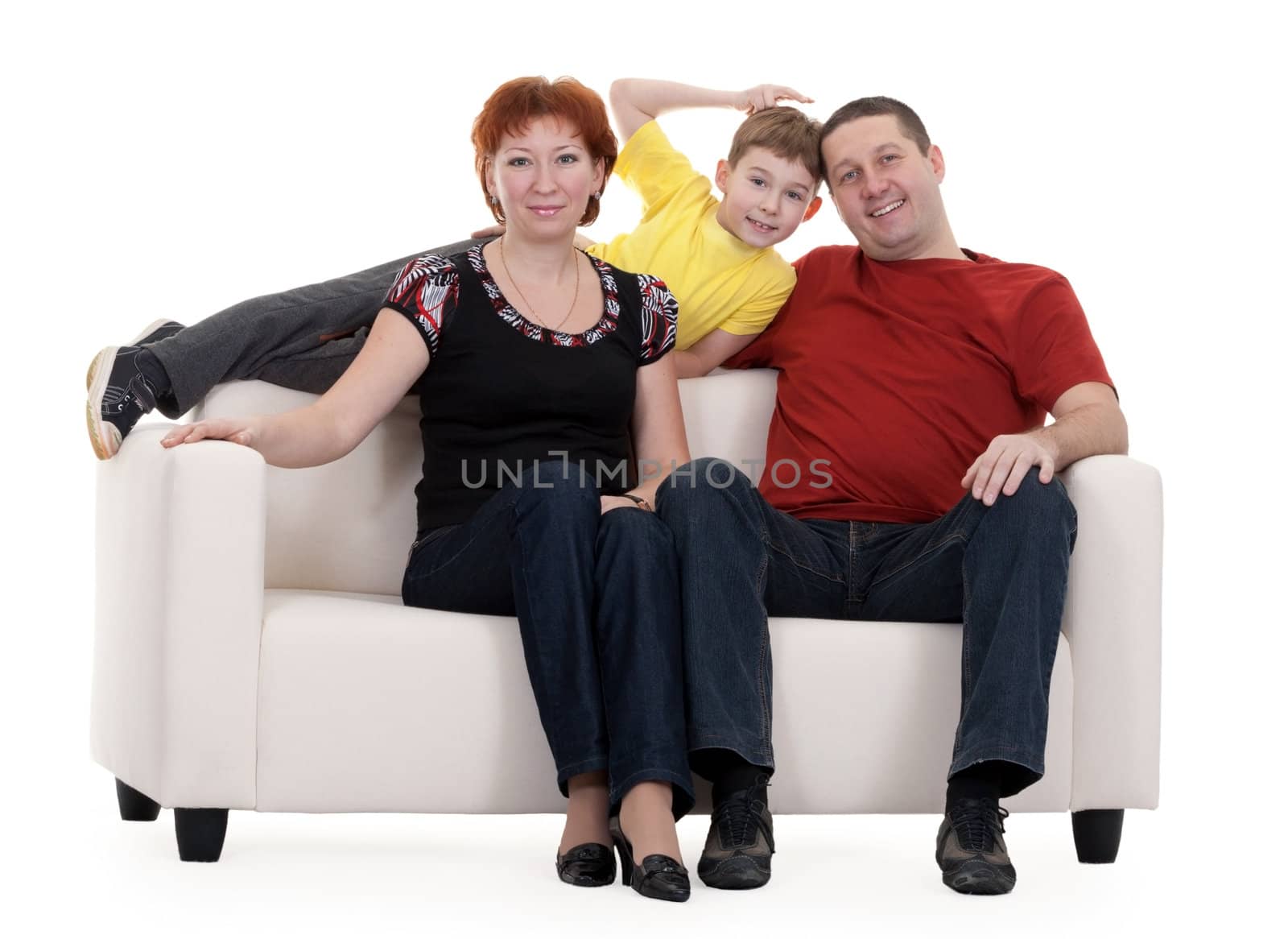family with son sitting on a sofa on a white background