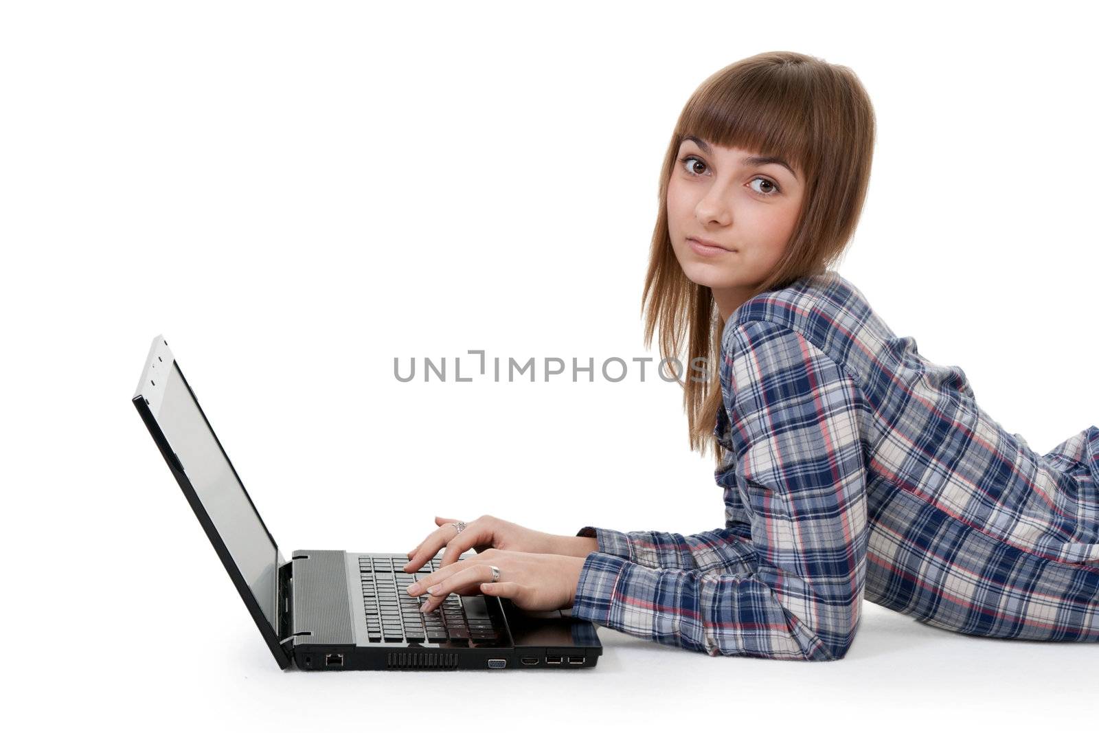 beautiful young girl lying on the floor with laptop