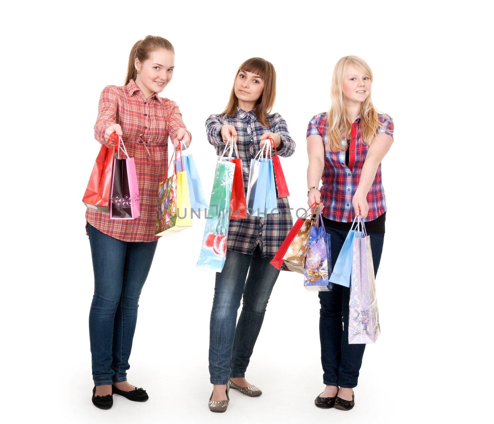 Three girls with colorful shopping bags on white background