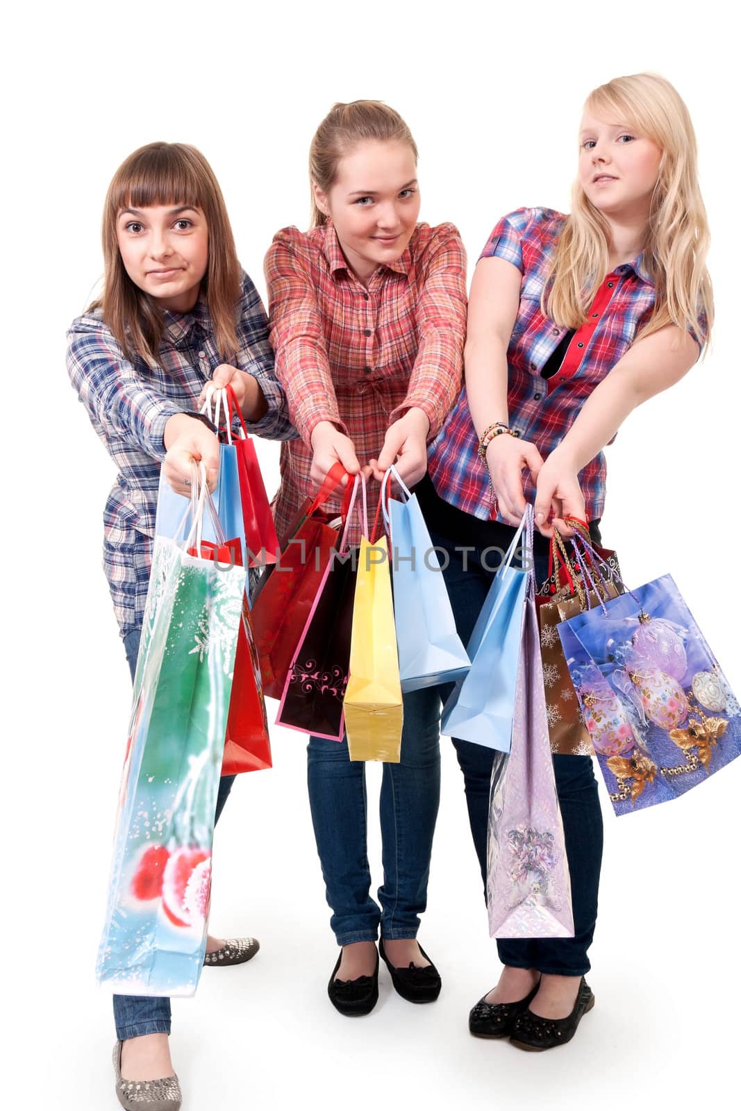 Three girls with colorful shopping bags on white background