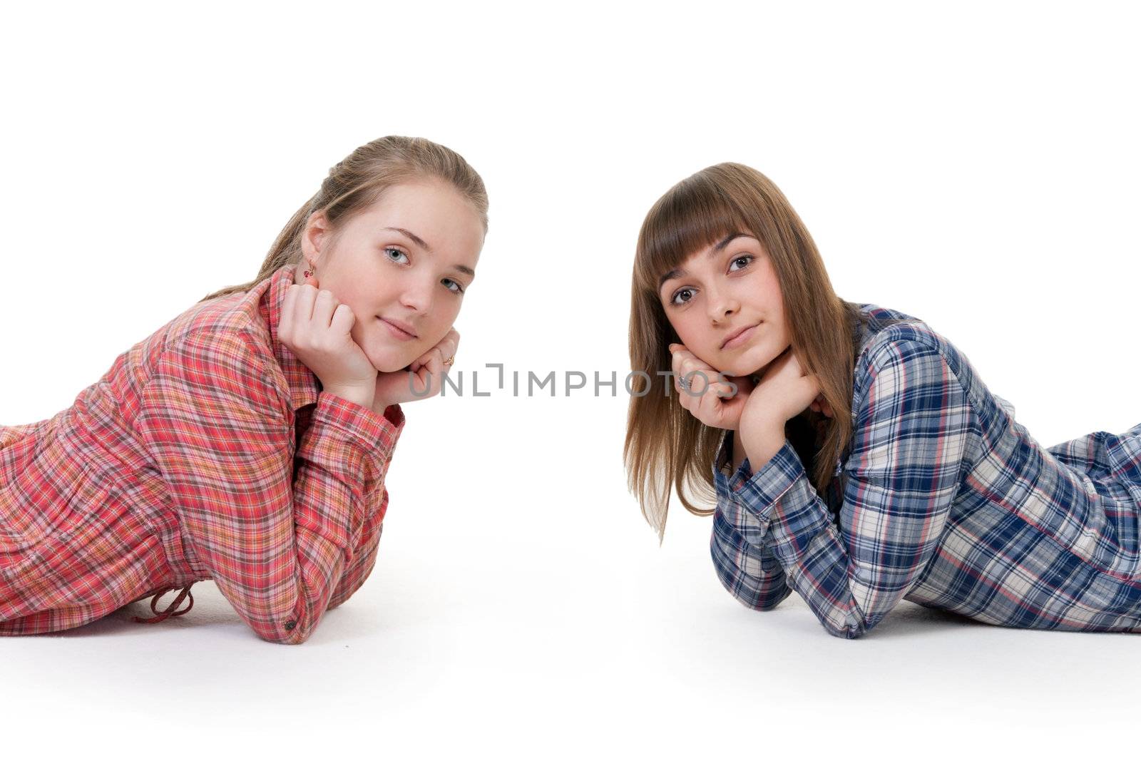 Two young beautiful girls lying on the floor