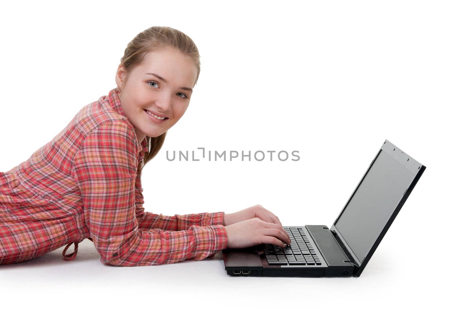 beautiful young girl lying on the floor with laptop