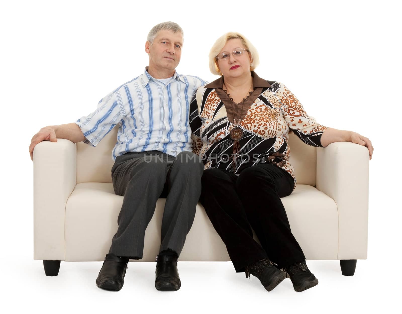 Mature couple sitting on a sofa on a white background