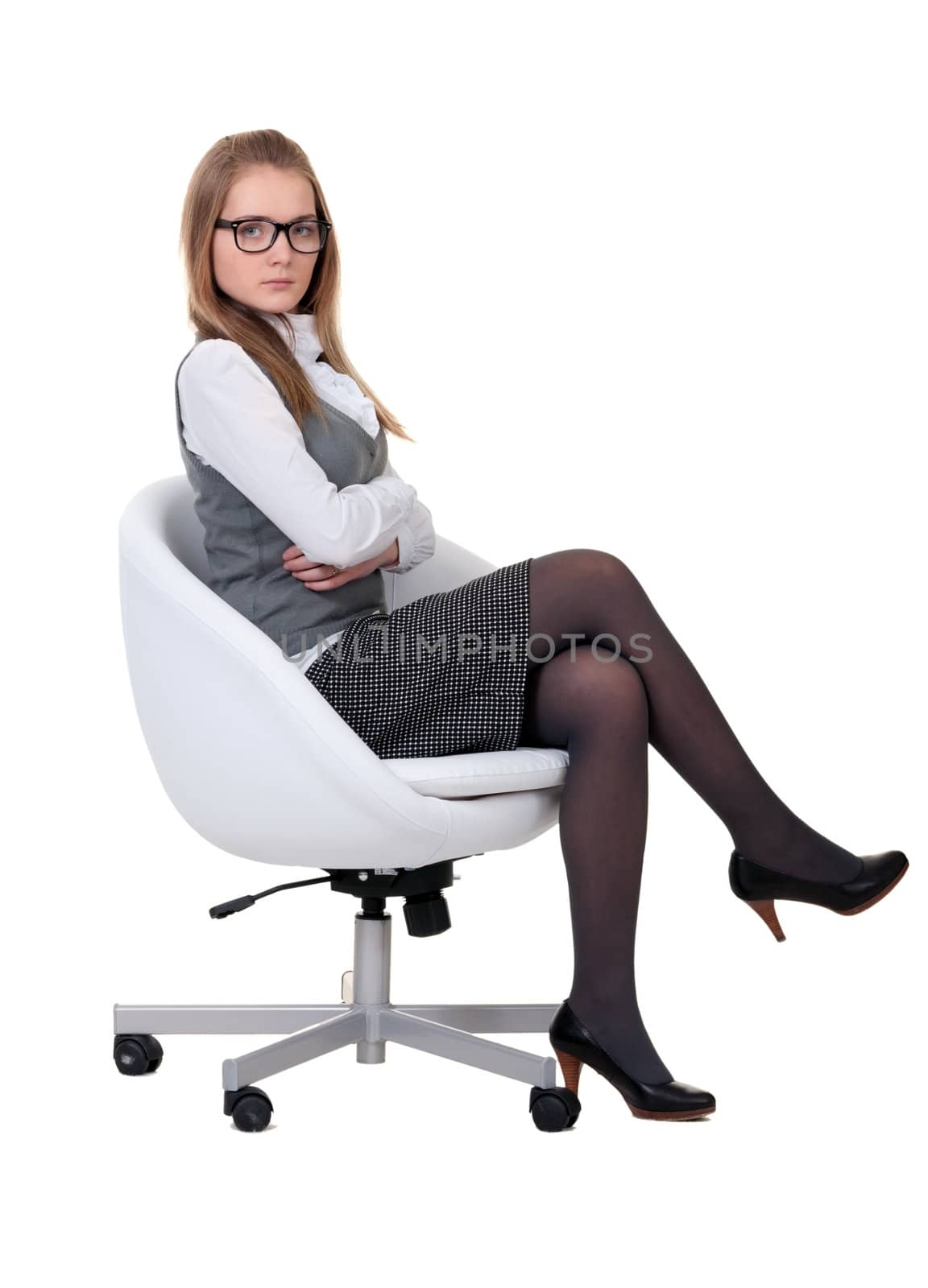 strong girl sitting in an armchair on a white background