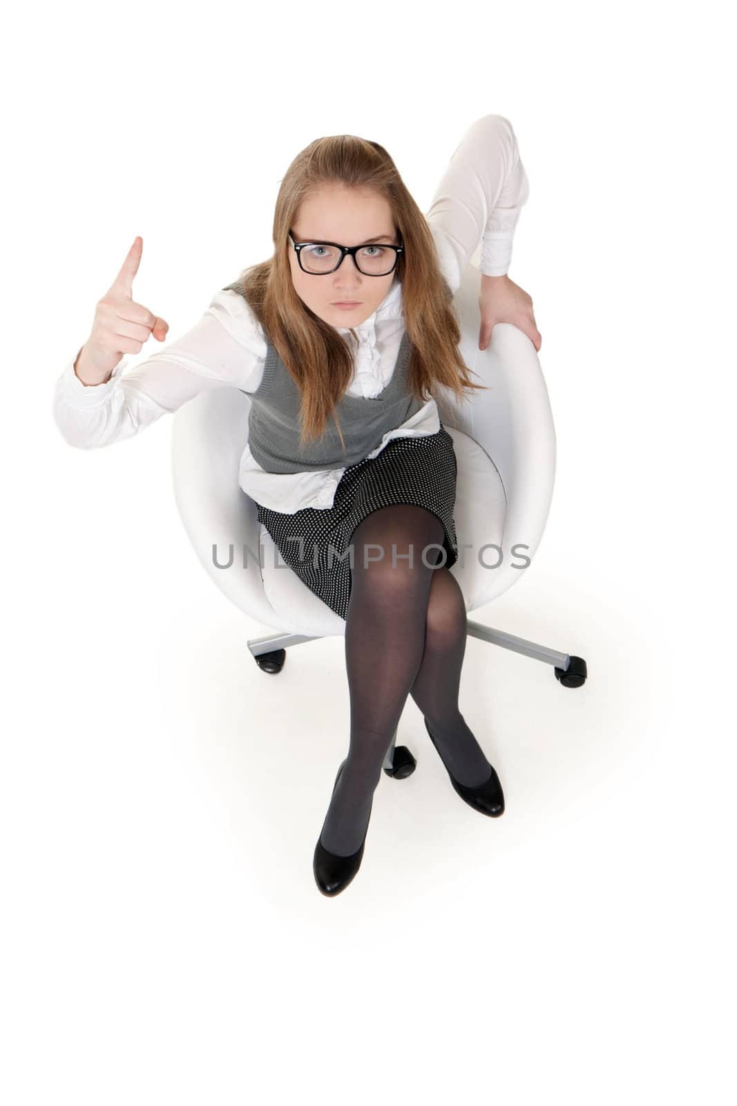strong girl sitting in an armchair on a white background