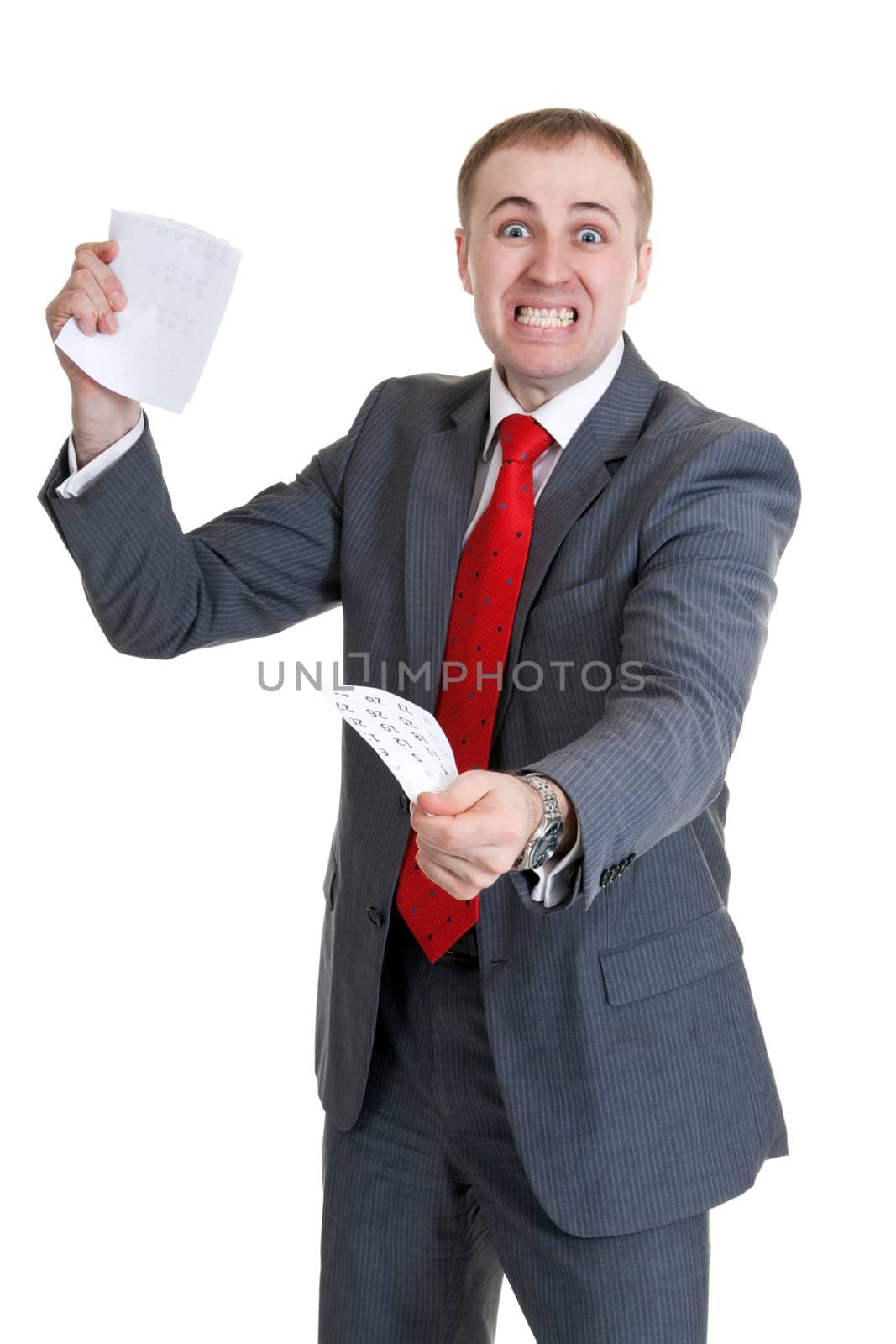 Young businessman in a rage tearing paper