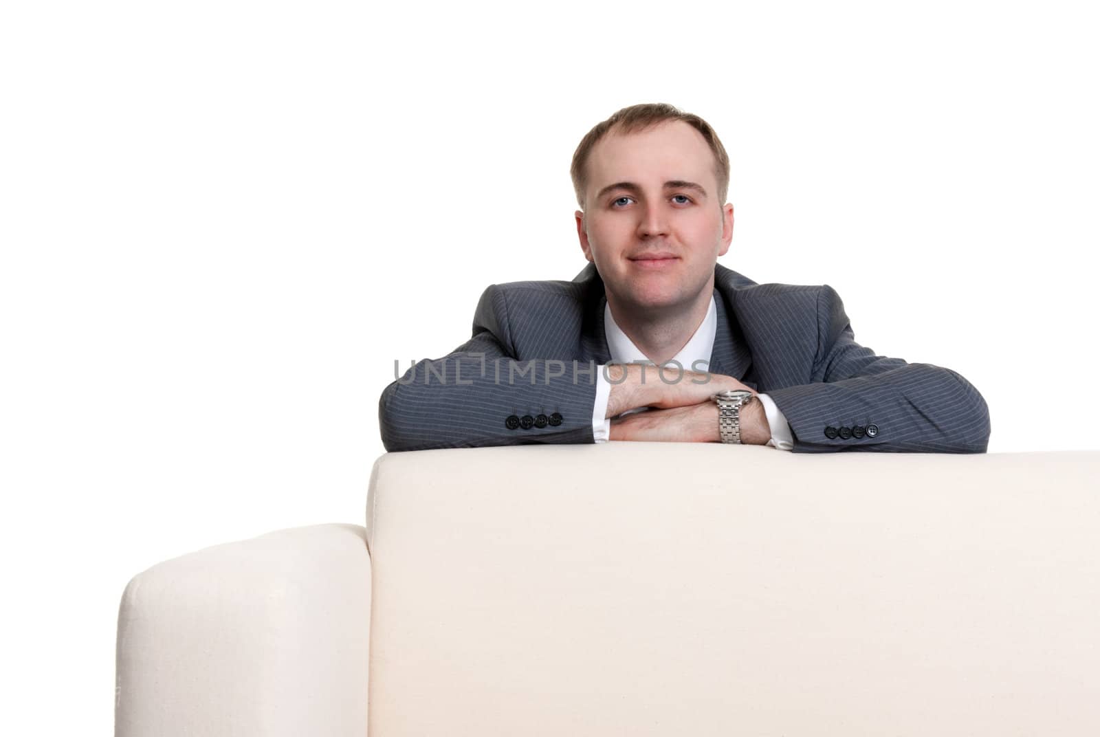 businessman looking out over the sofa on a white background