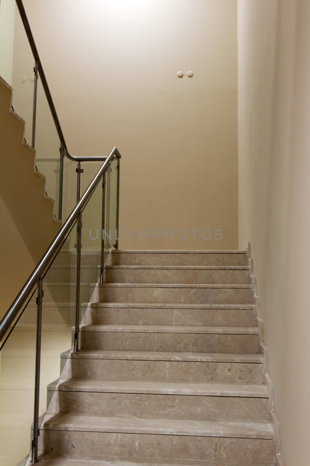 Corridor and the marble staircase with steel handrails