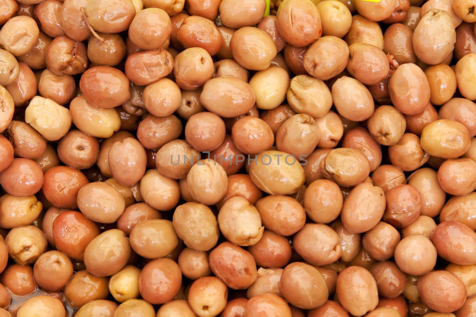 Background of ripe marinated olives at the market