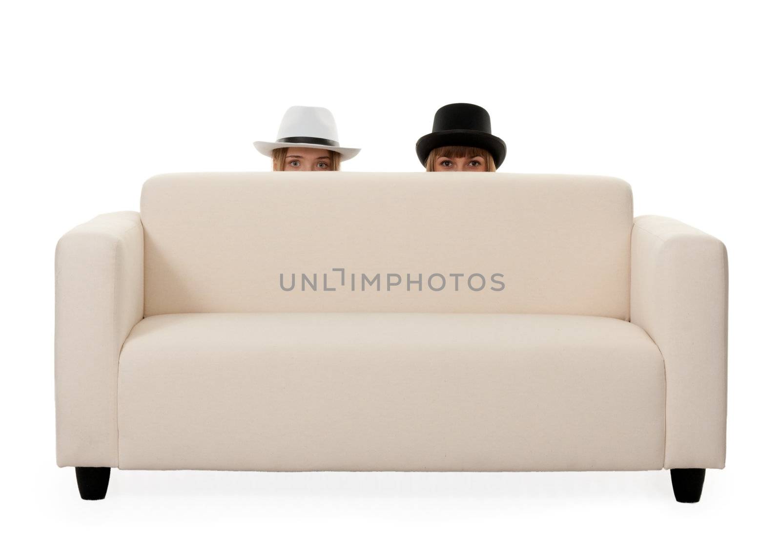 Two girls on the couch with a mustache painted on a white background