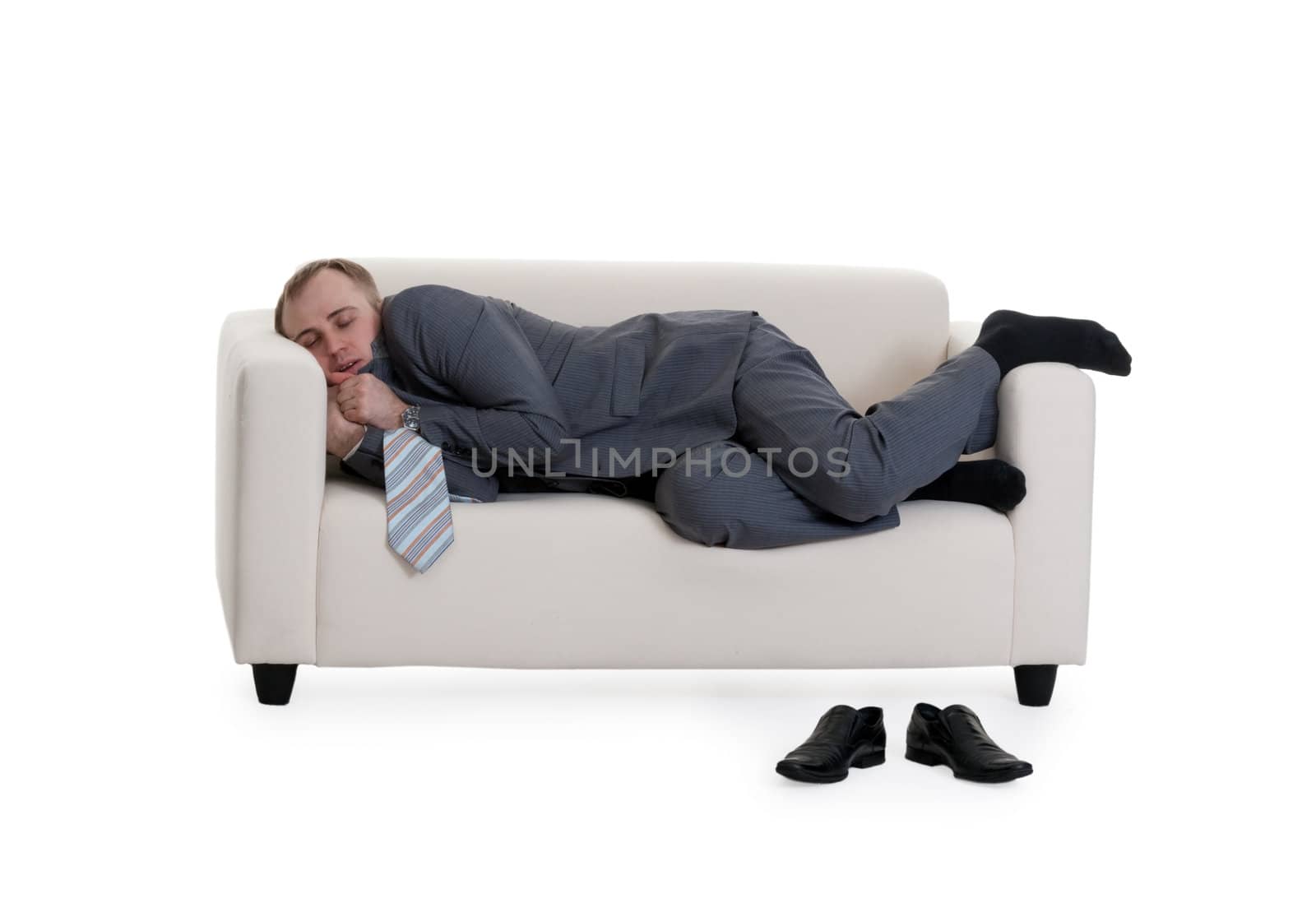 businessman sleeping on a sofa on a white background