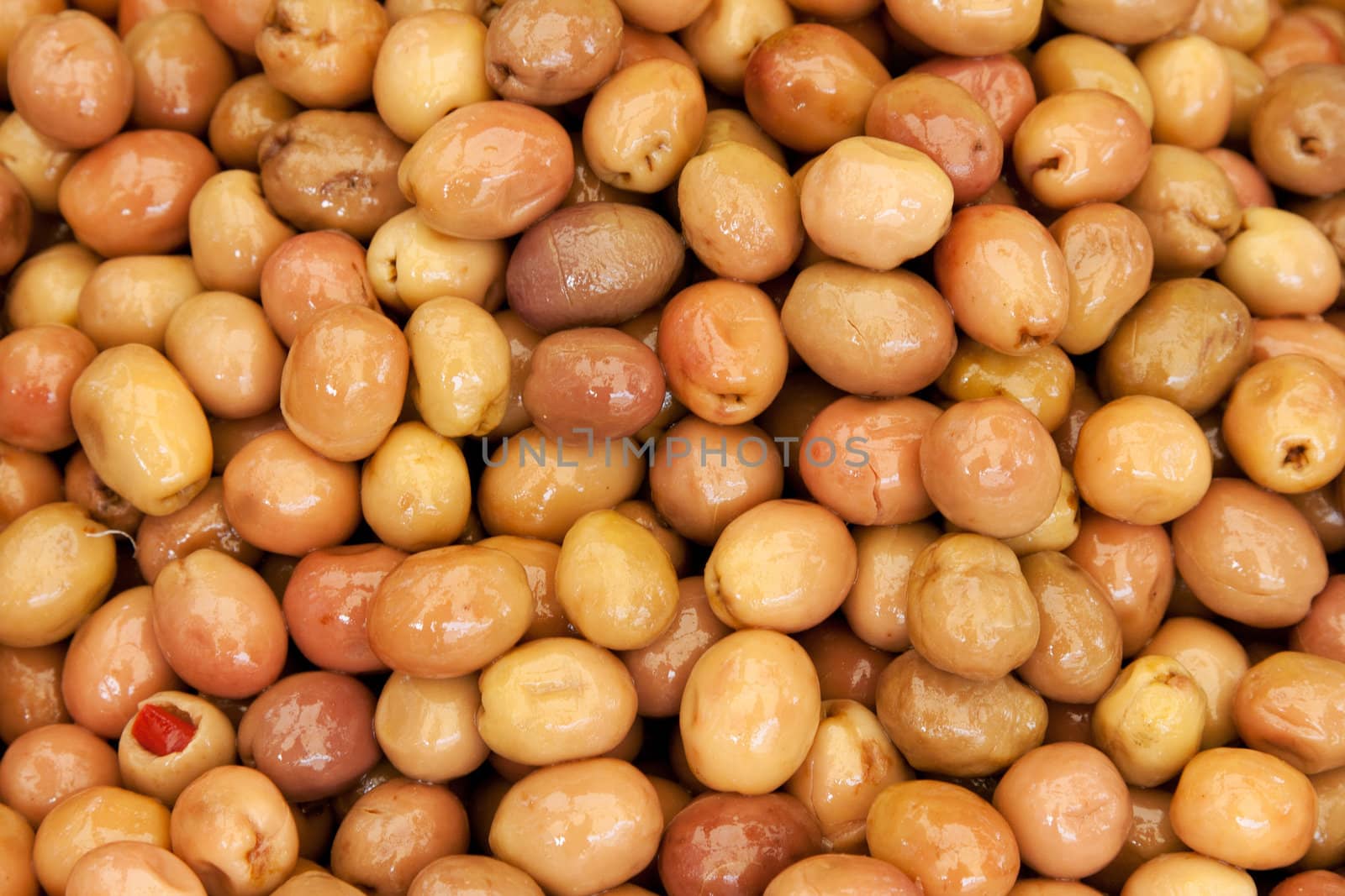 Background of ripe marinated olives at the market