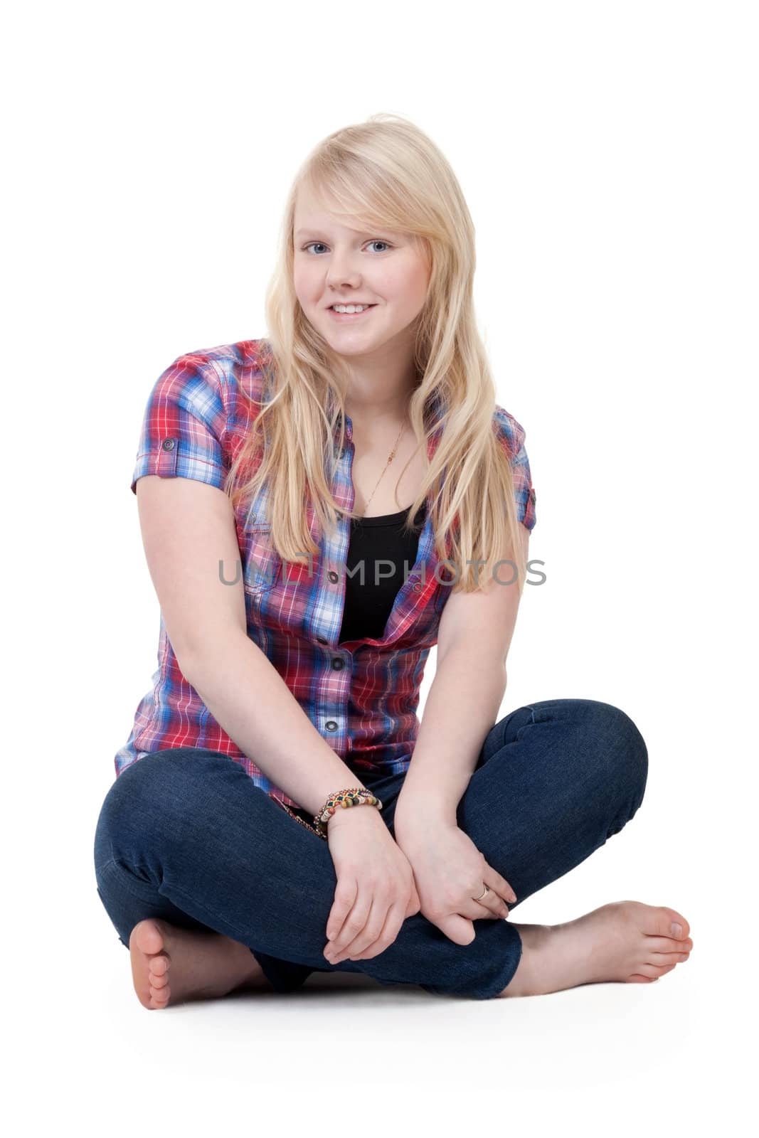 Beautiful girl in a plaid shirt sitting in the lotus position