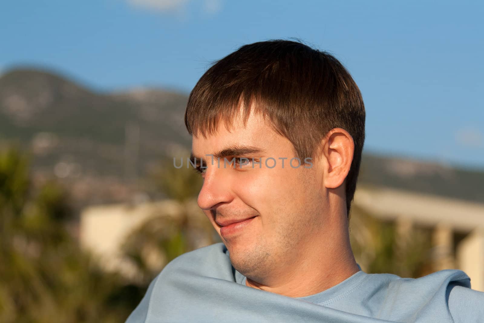 portrait of a man against the backdrop of greenery
