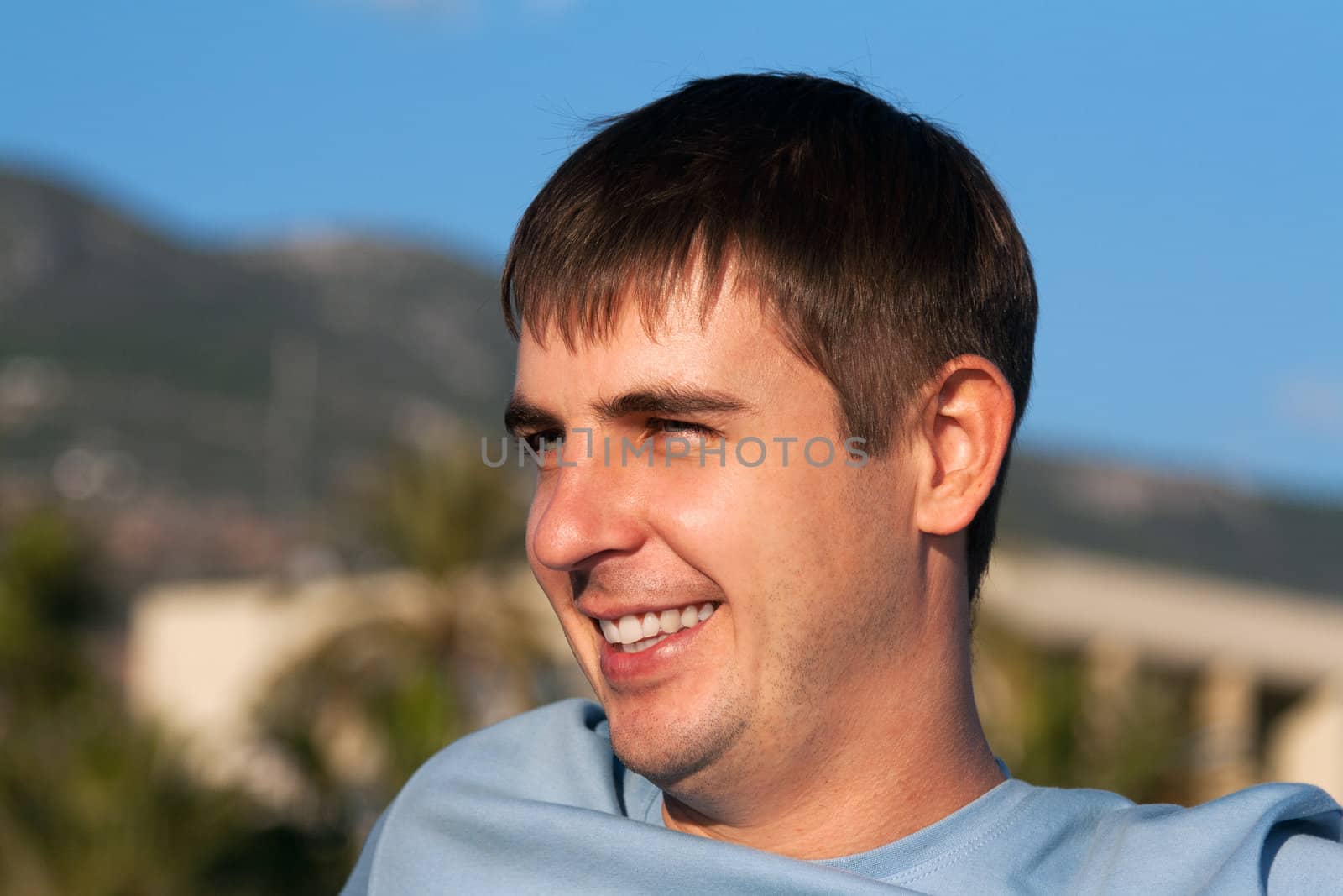 portrait of a man against the backdrop of greenery