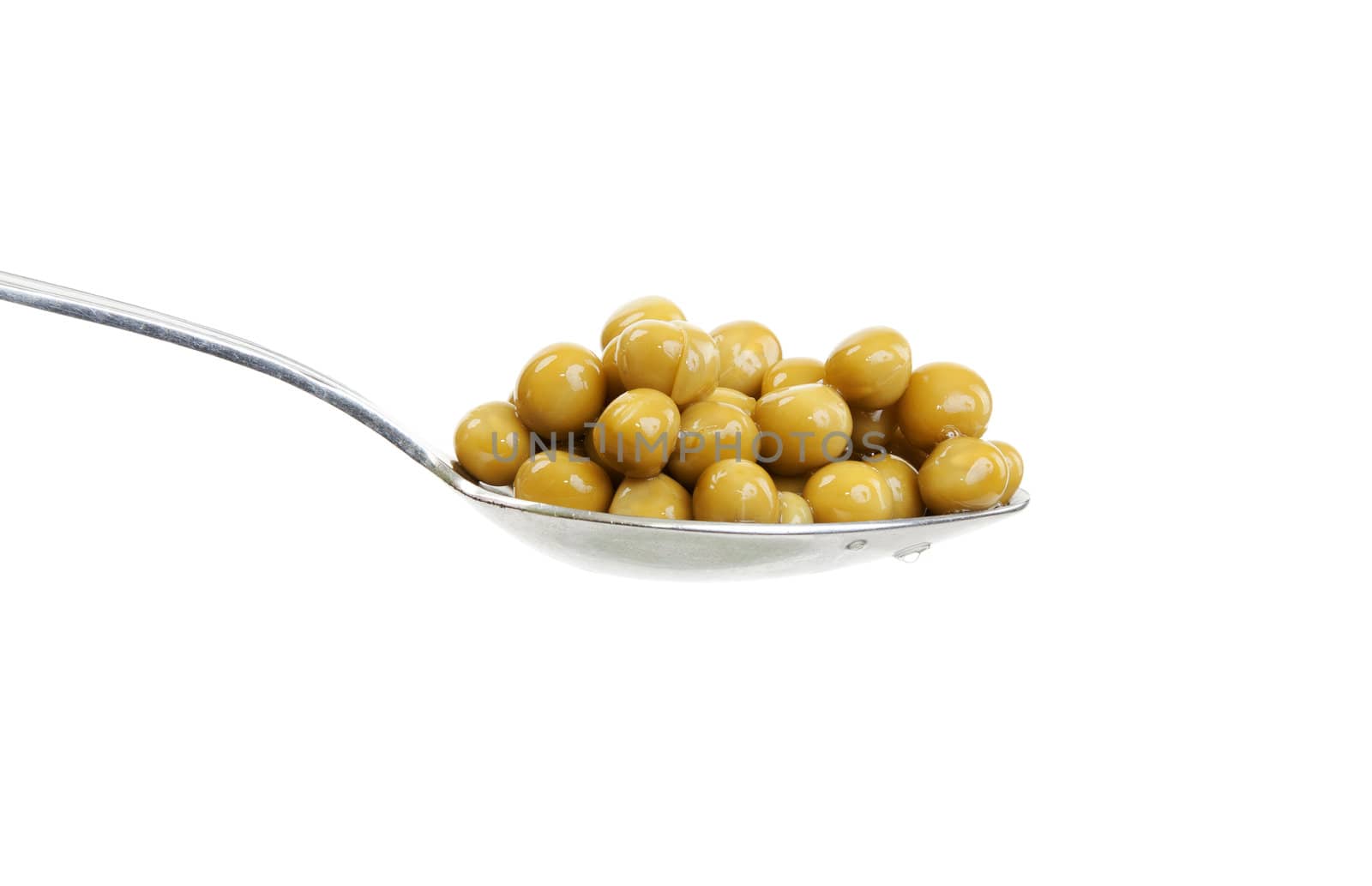 Spoon with green peas on a white background