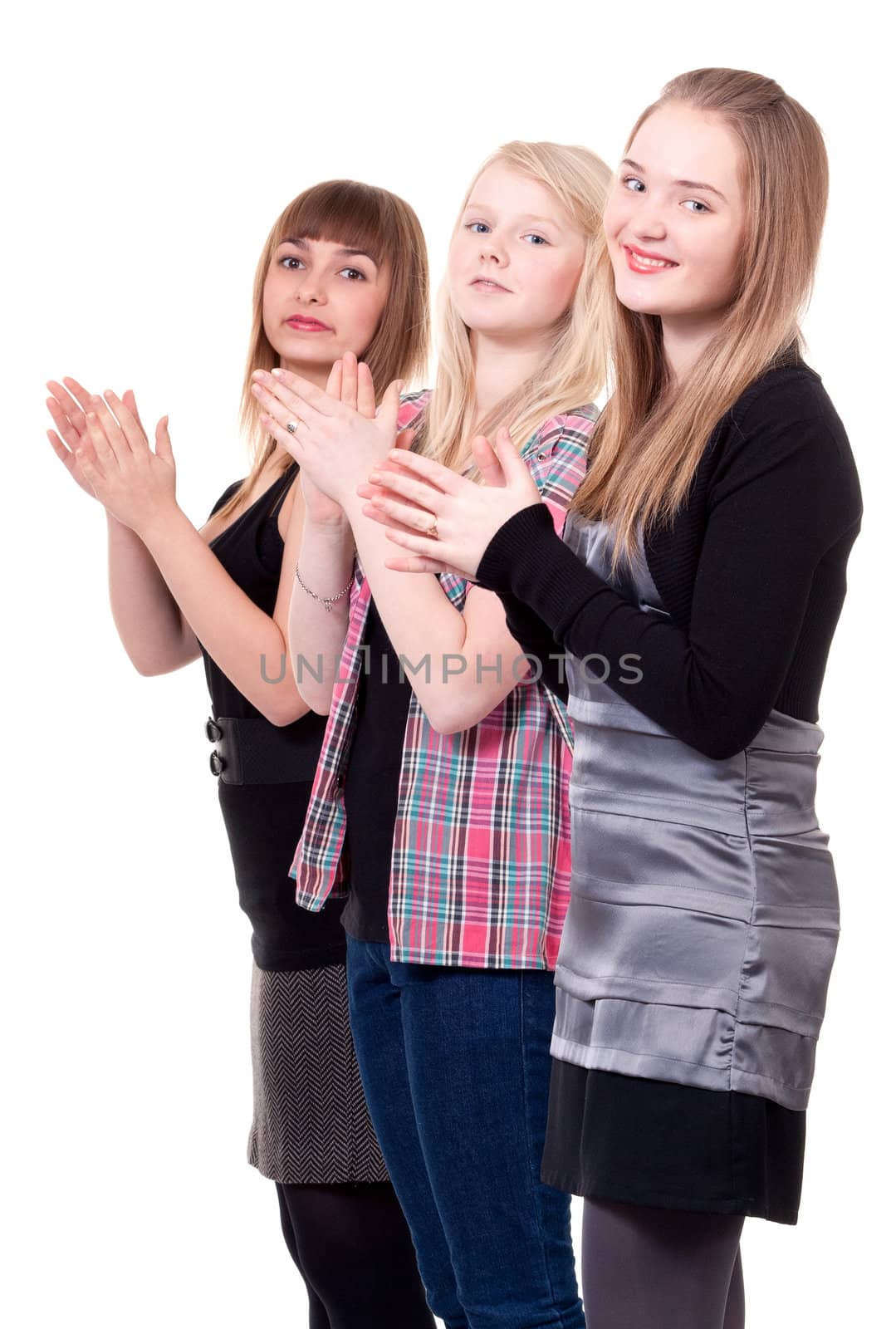 Three young girls clap on a white background