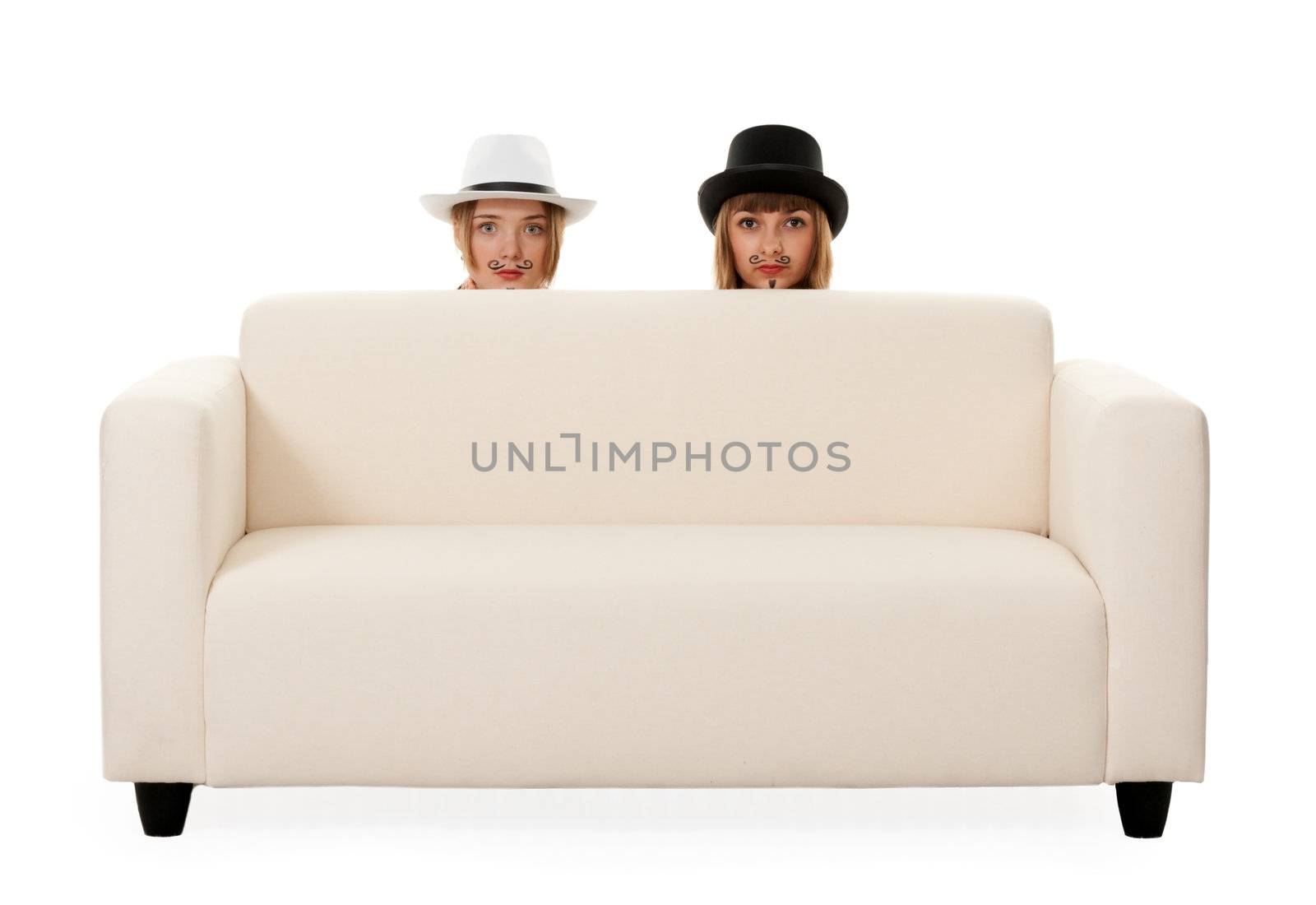 Two girls on the couch with a mustache painted on a white background