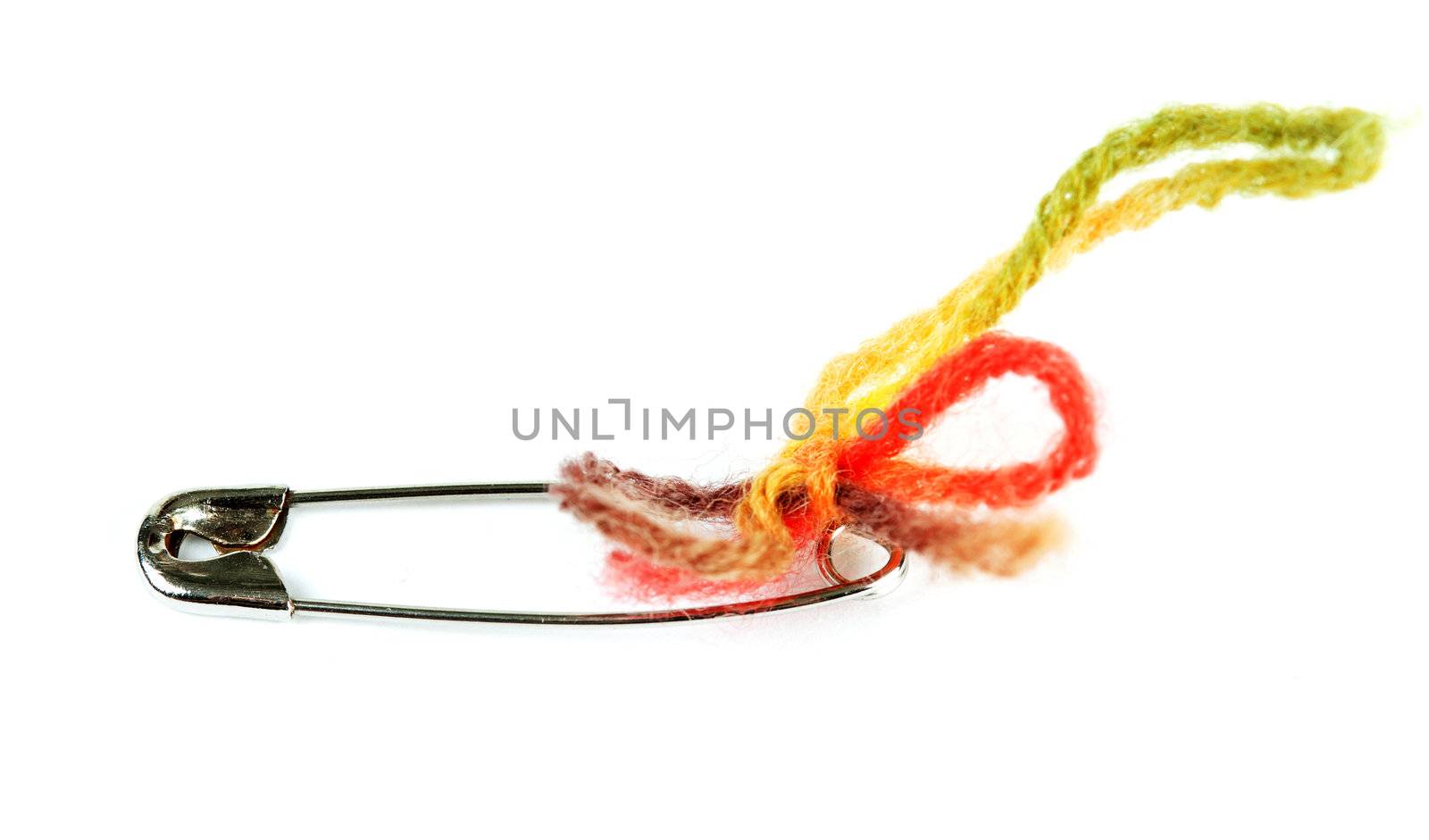 steel pin with a colored thread on a white background