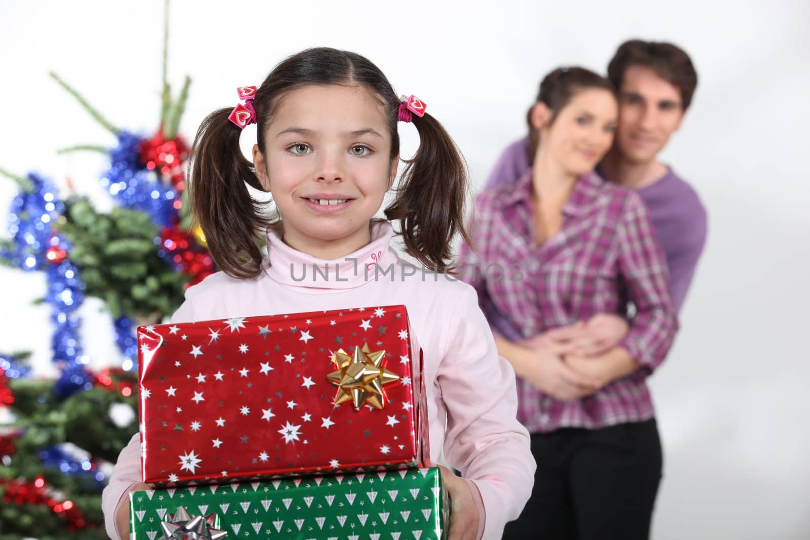 Girl and parents with Christmas presents