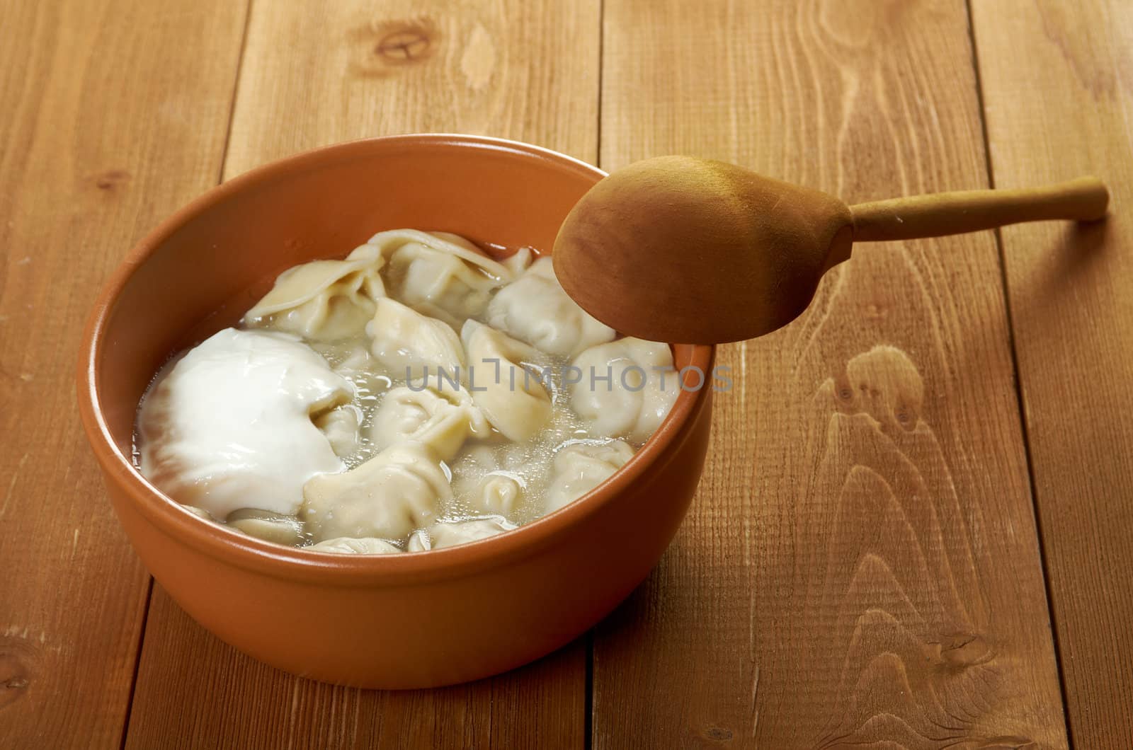 Traditional Russian food "pelmeni".Meat dumplings  with sour cream