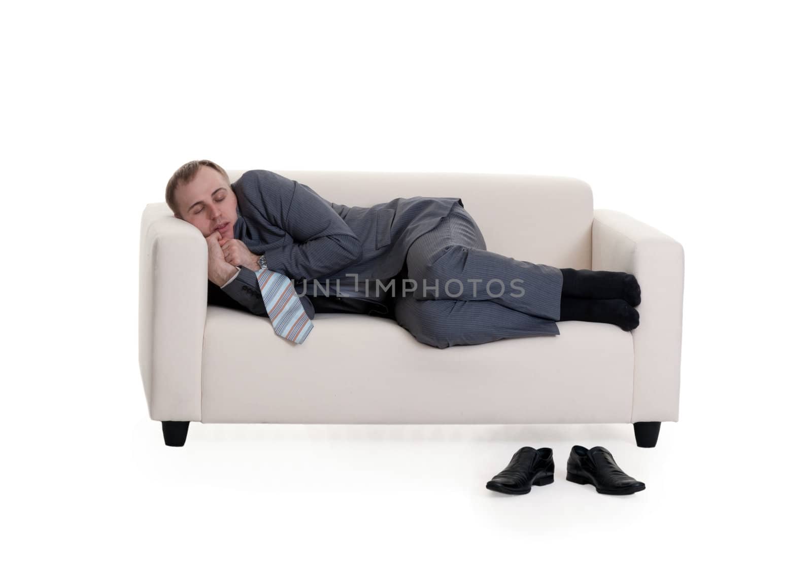 businessman sleeping on a sofa on a white background