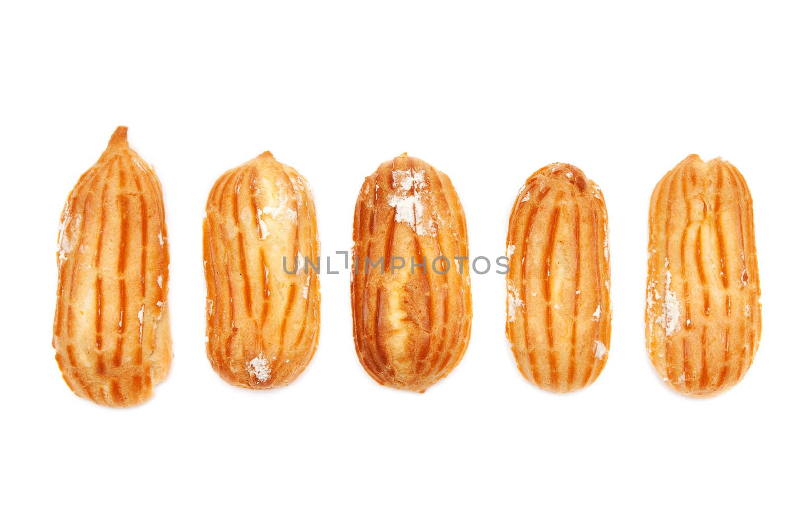 Delicious eclairs arranged unlikely on a white background