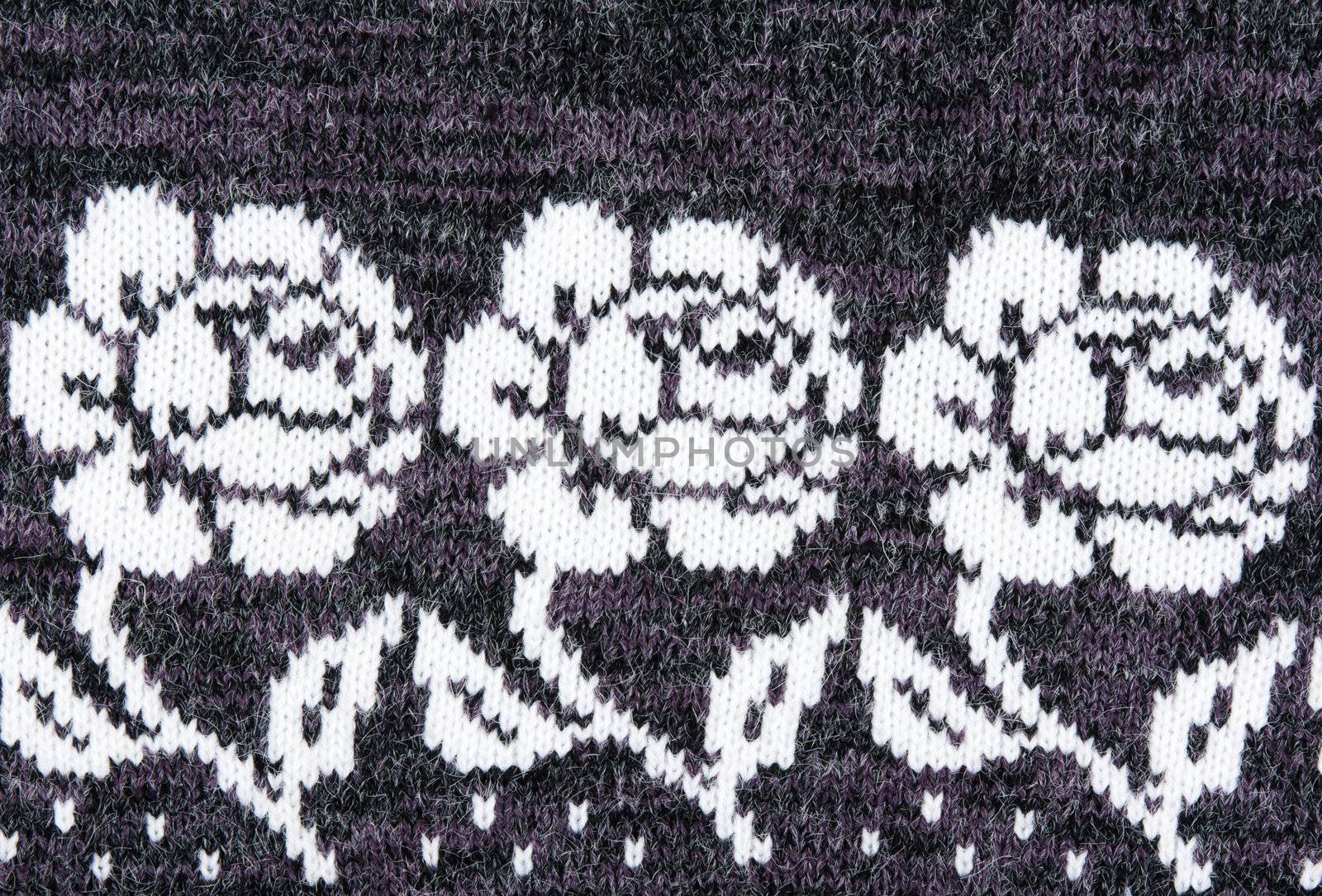 knitted gray background with a pattern in the form of a flower