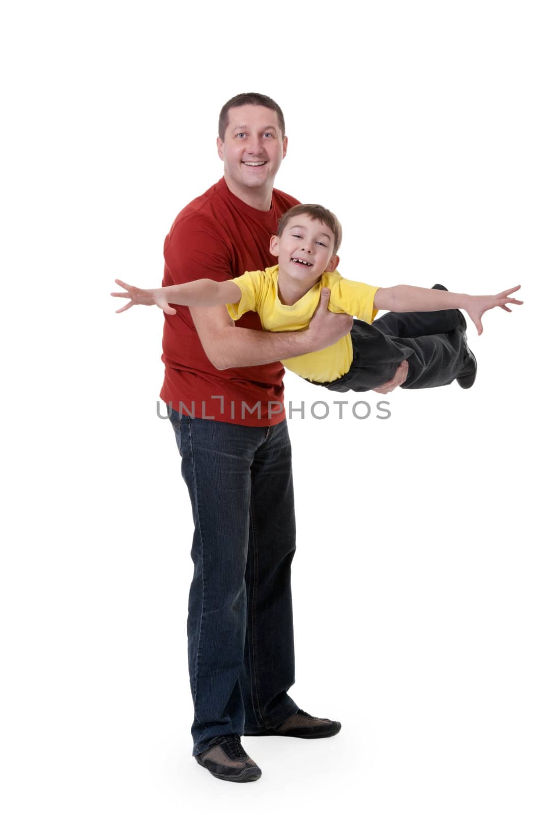 Dad keeps his son in his arms on a white background