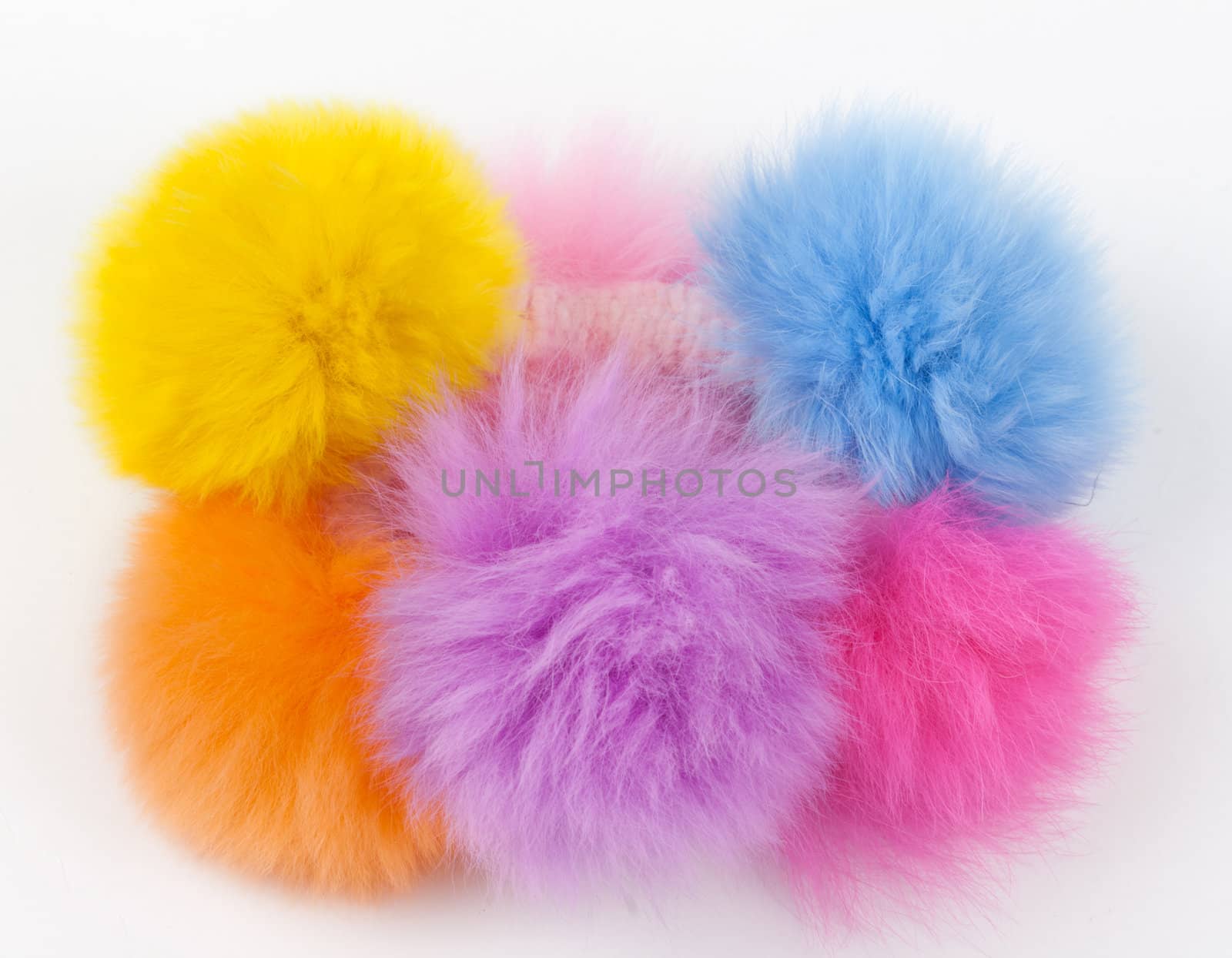 fur hair-slide from the colored balls on a light background