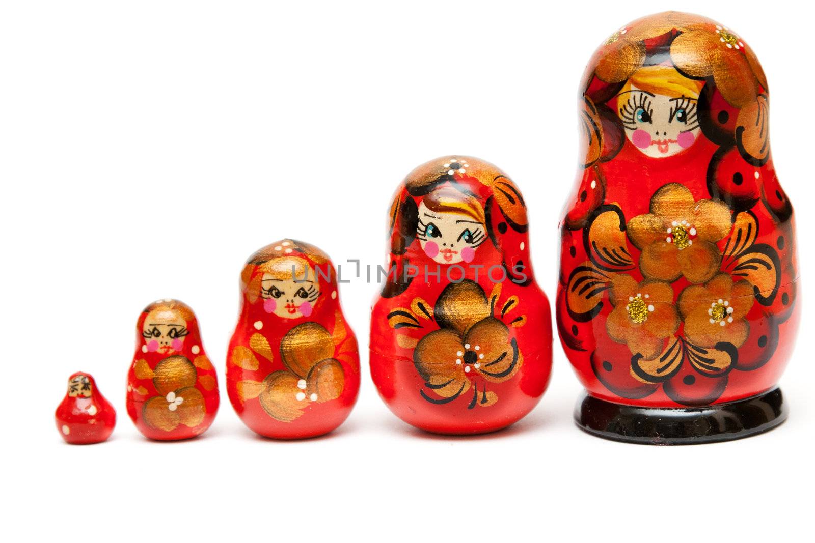 Russian nesting dolls stand in a row on a white background