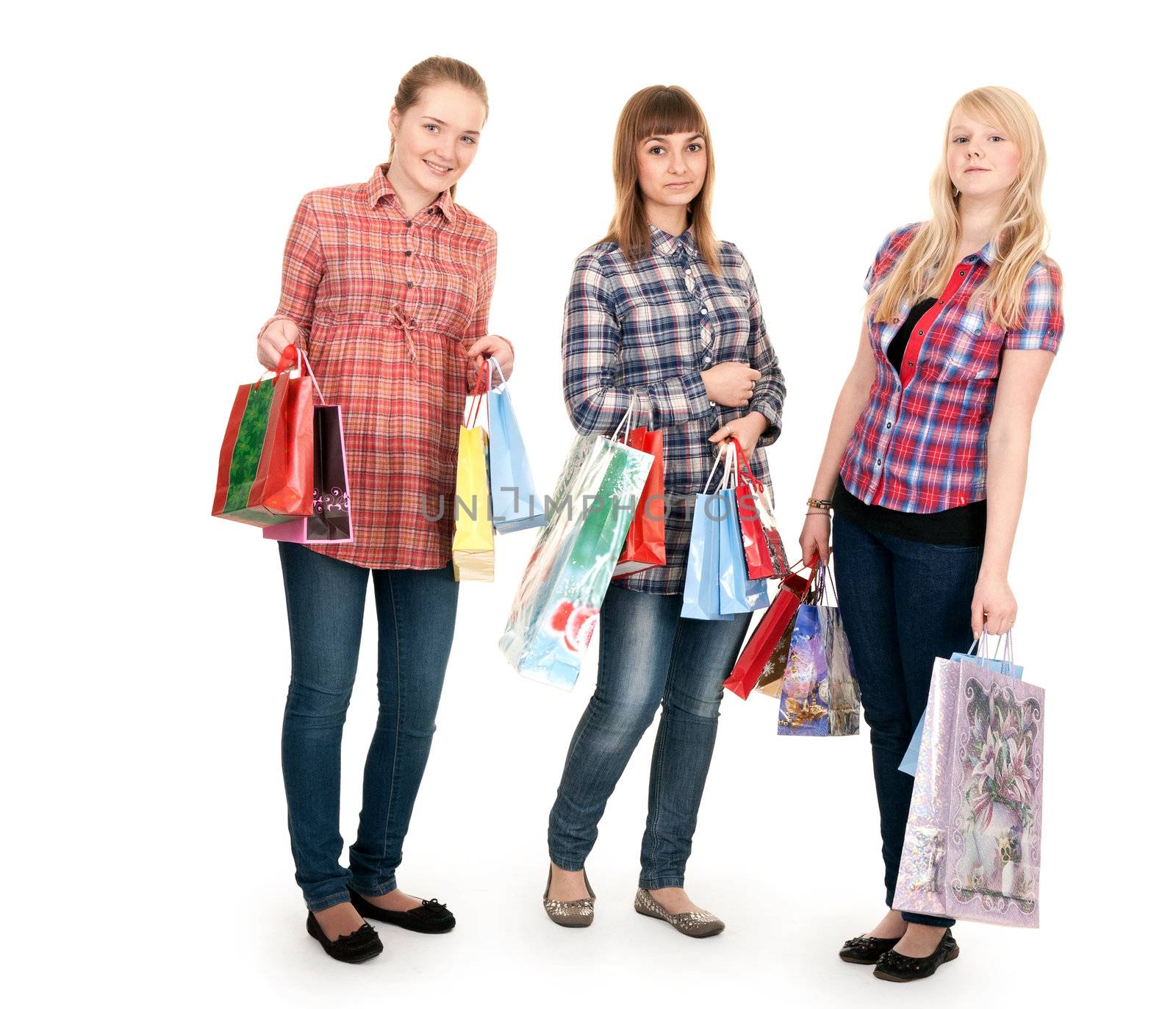 Three girls with colorful shopping bags on white background