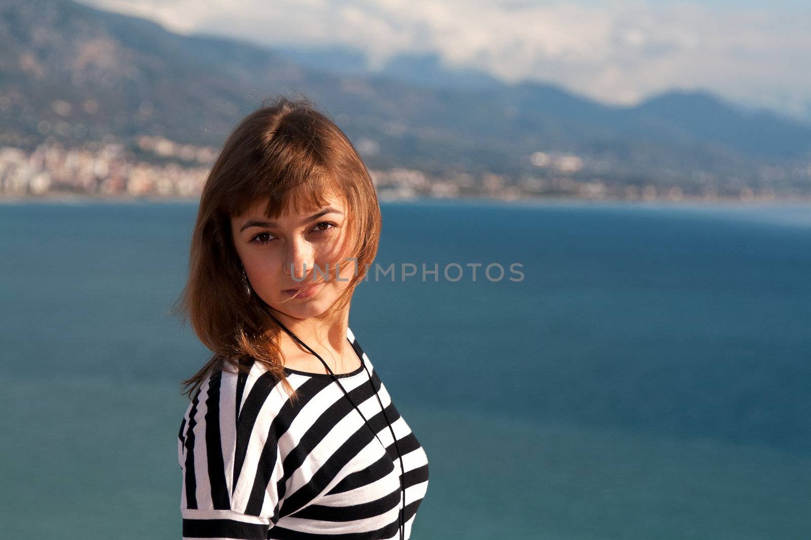 Beautiful girl on the background of the coast