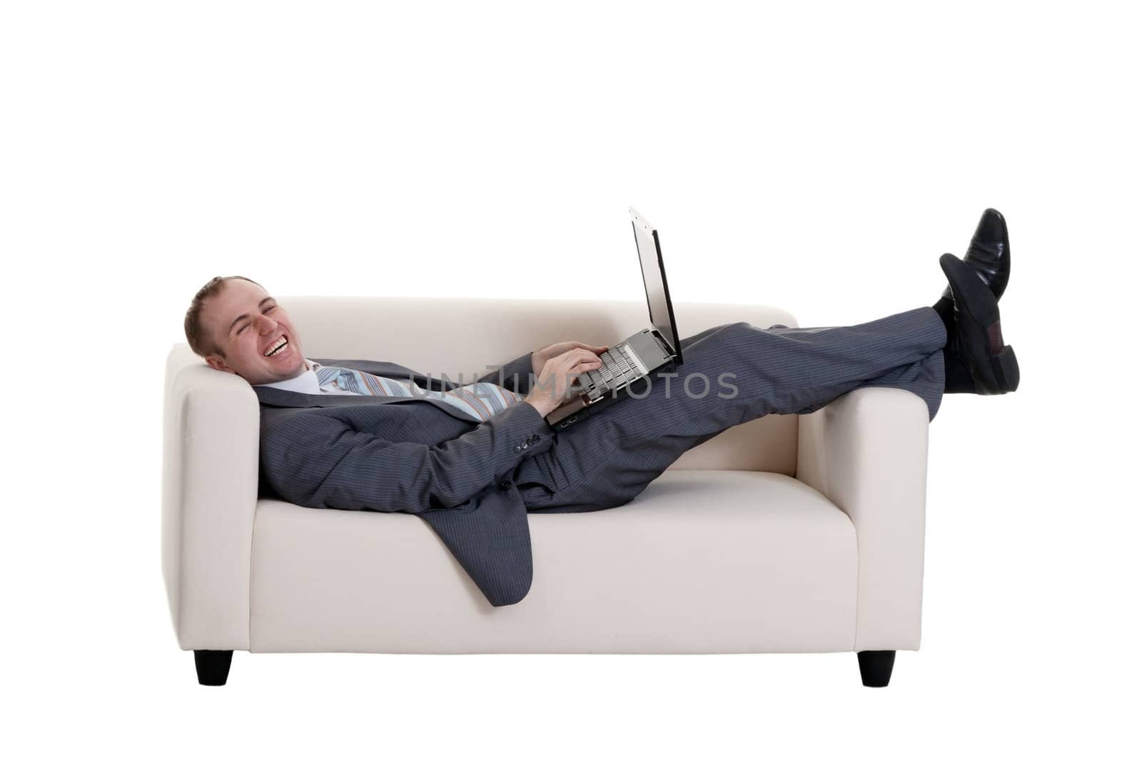 businessman lying on the couch with a laptop on a white background