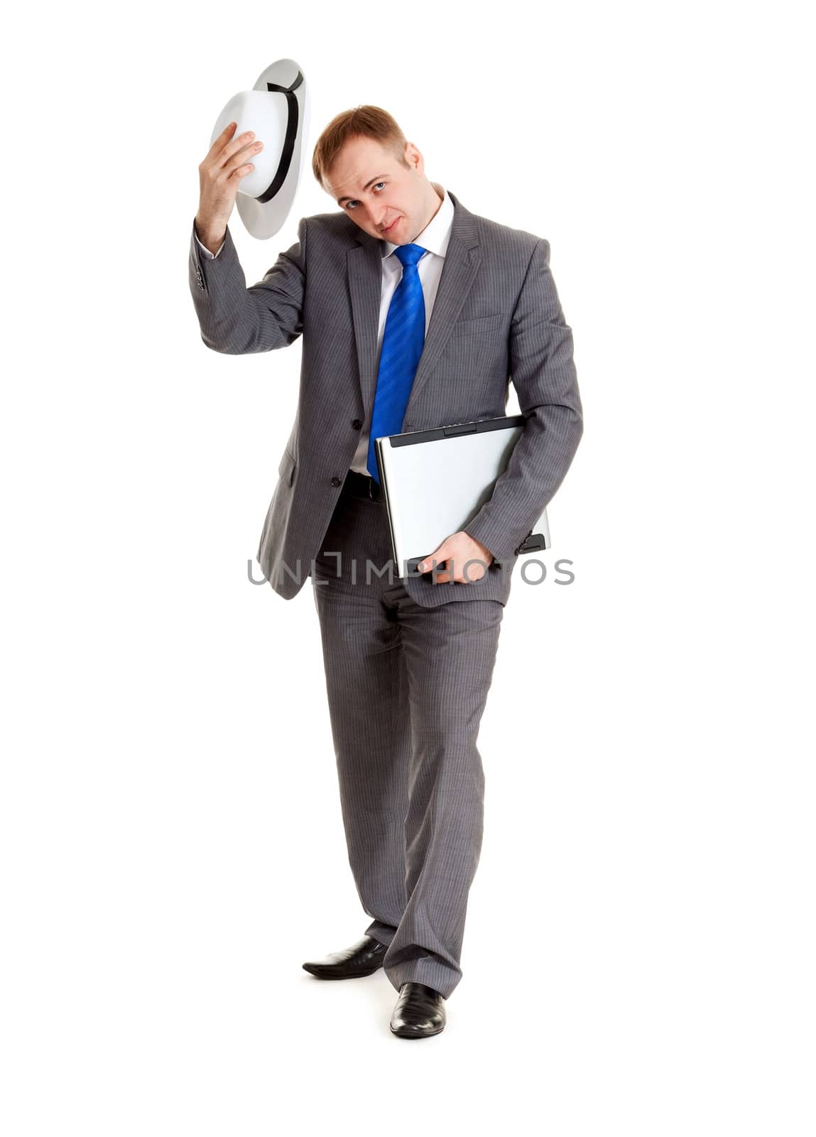 Young businessman in a suit and a hat with a laptop