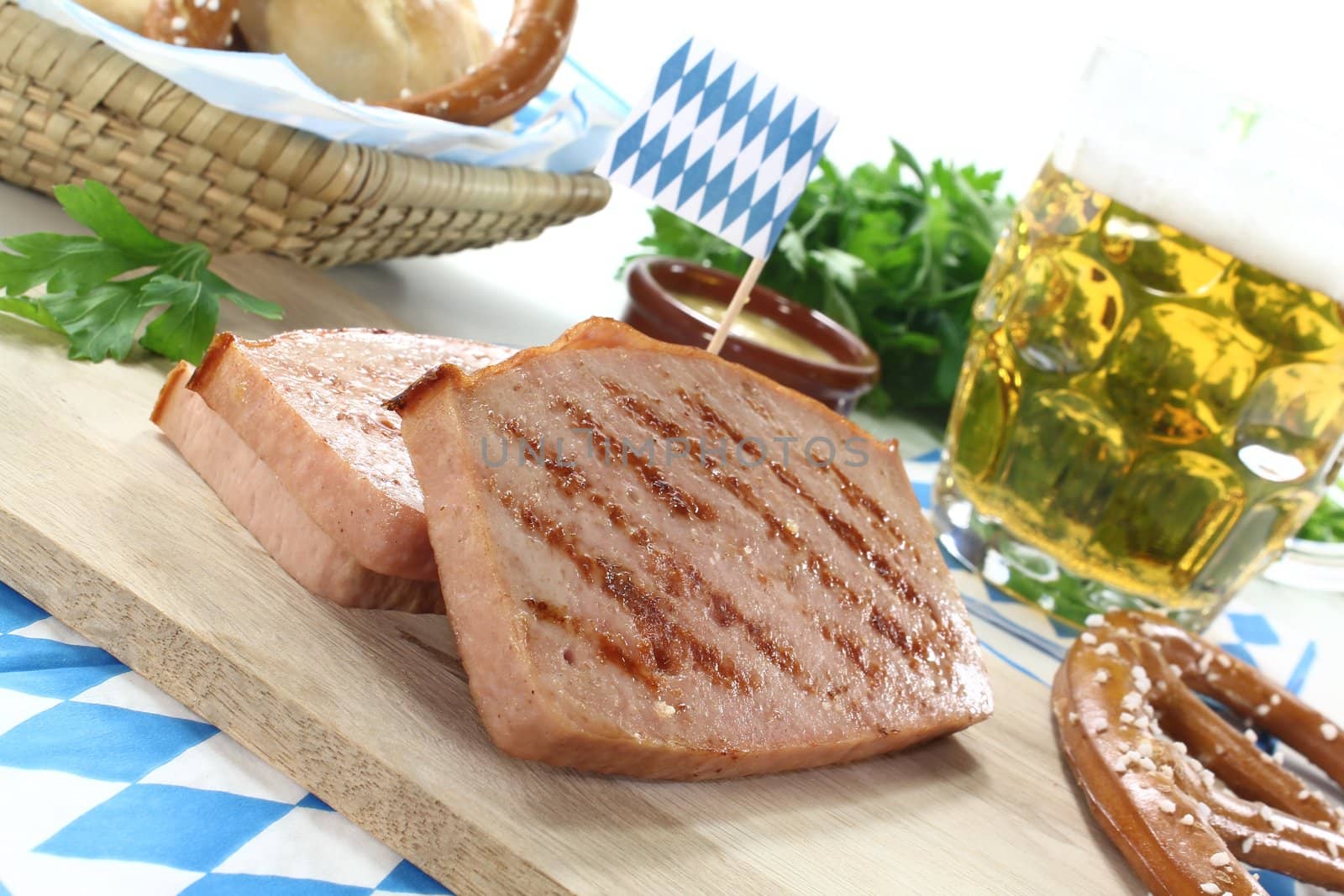 fresh Bavarian beef and pork loaf with pretzels and mustard on a light background