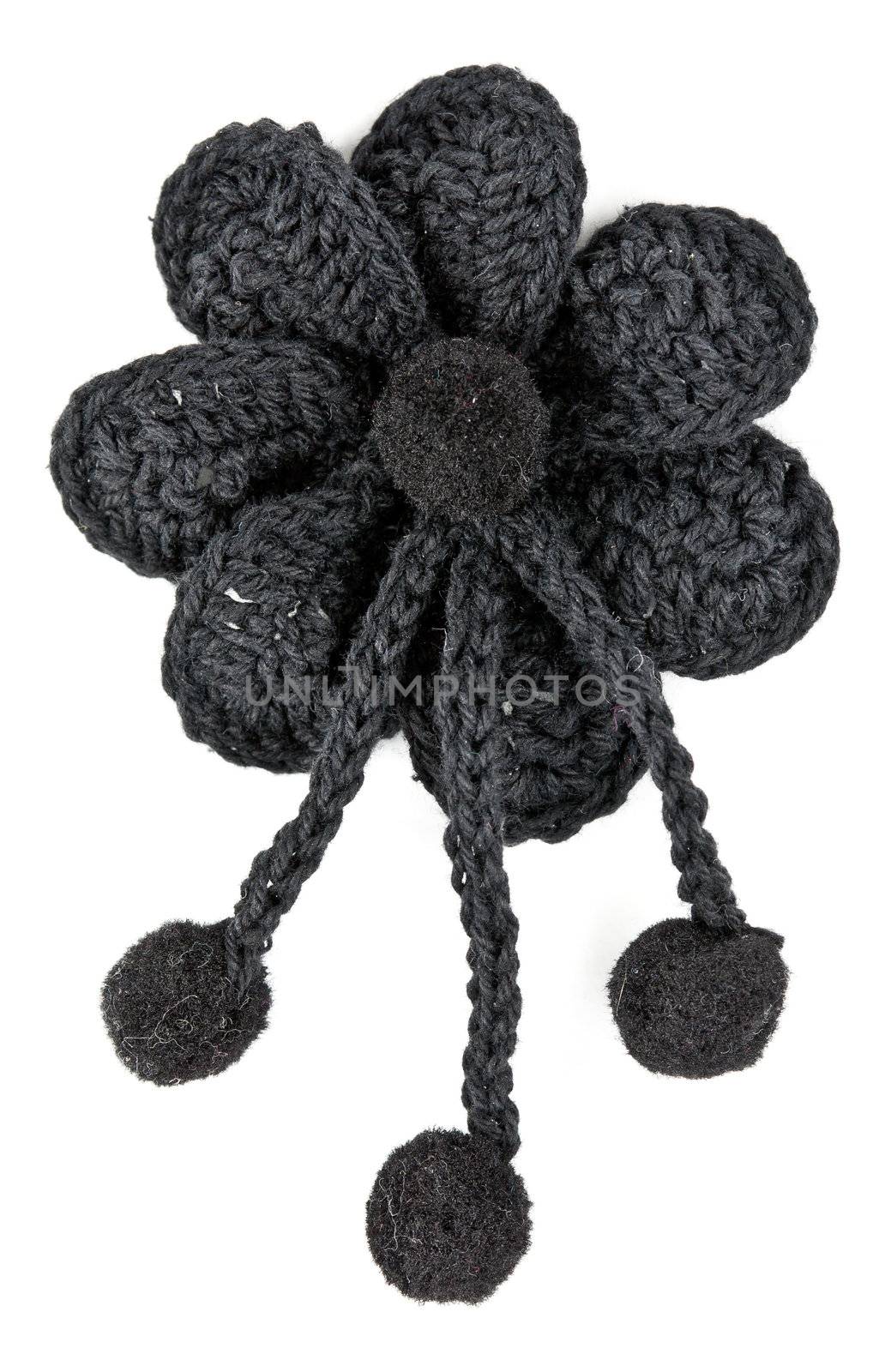 black knitted fabric flower on a white background