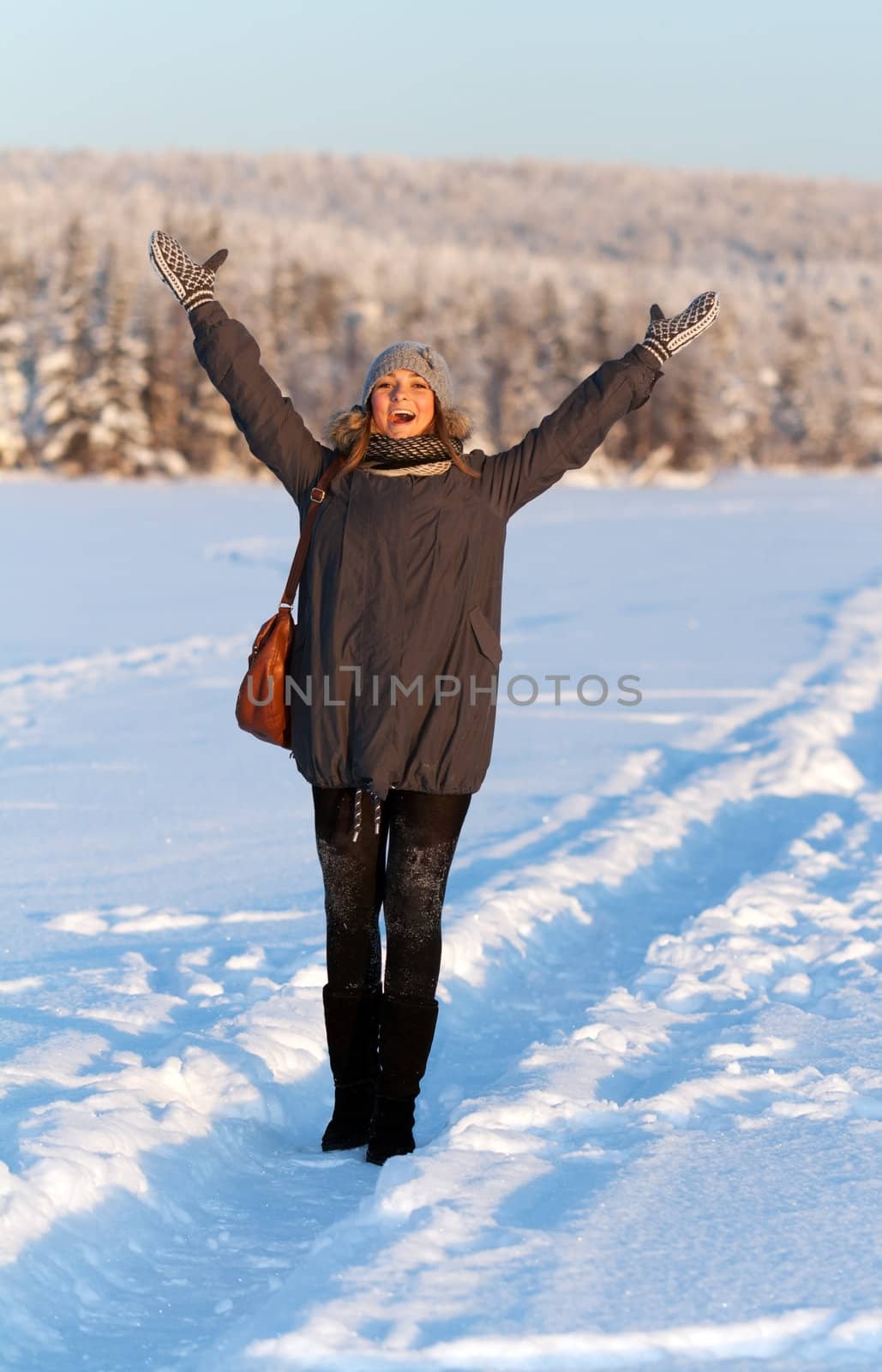 portrait of a beautiful young girl in the sunlight in the cold