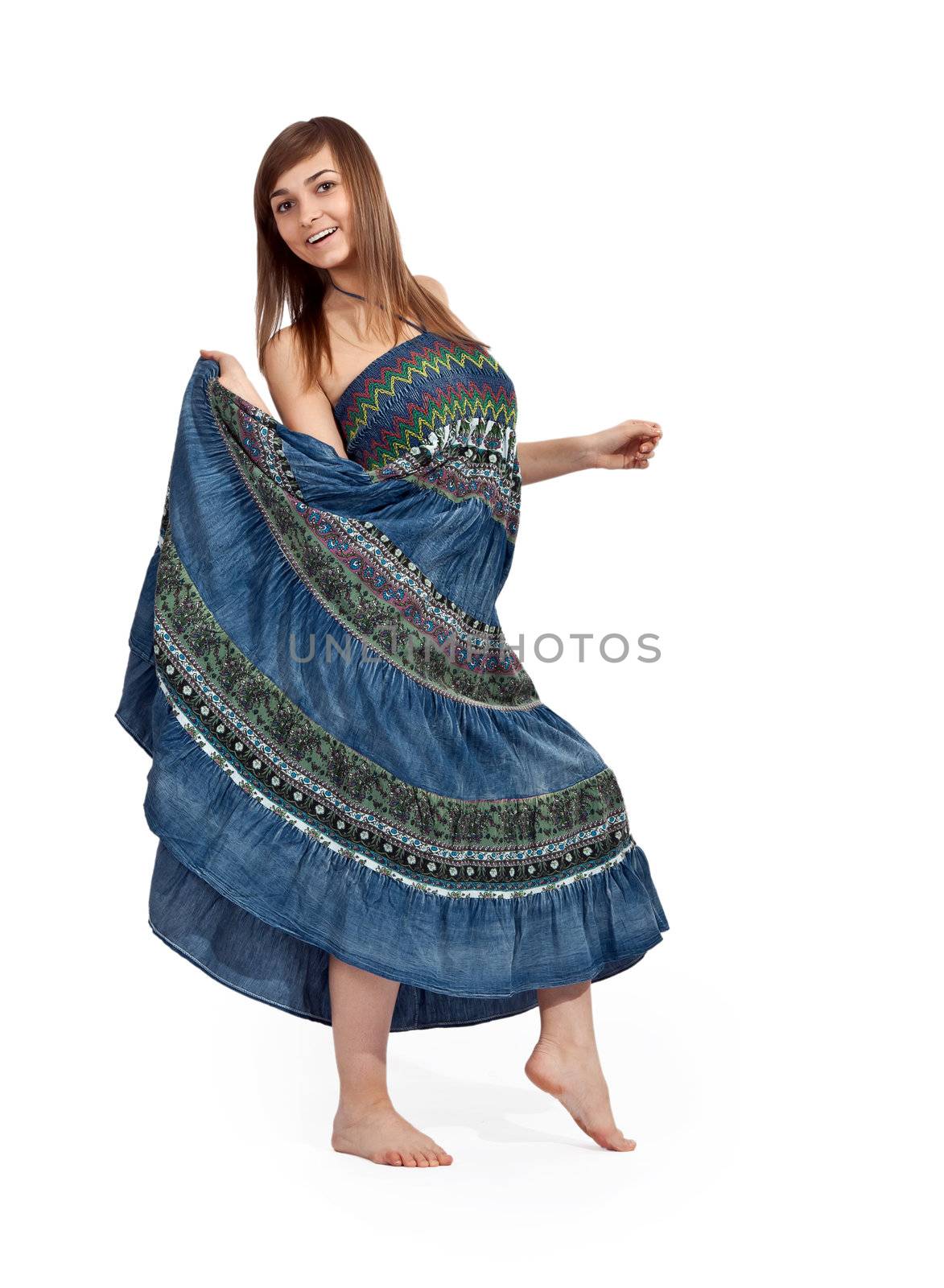 beautiful girl in jeans sarafan dancing on a light background