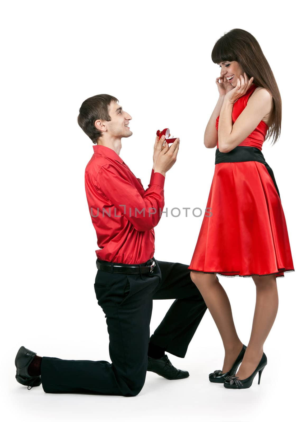 man gives the woman a ring on her knees
