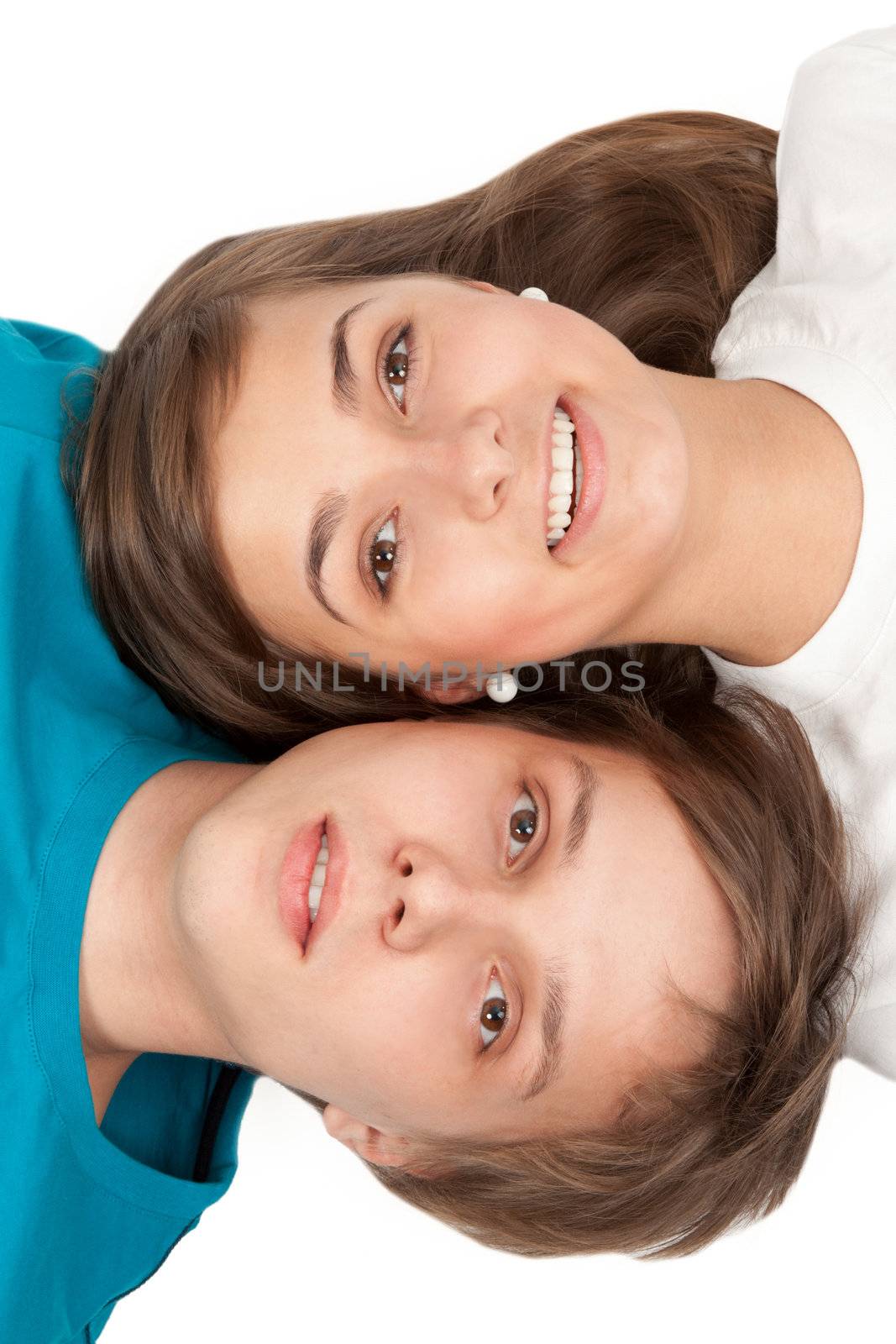 Boy and girl lying on white floor