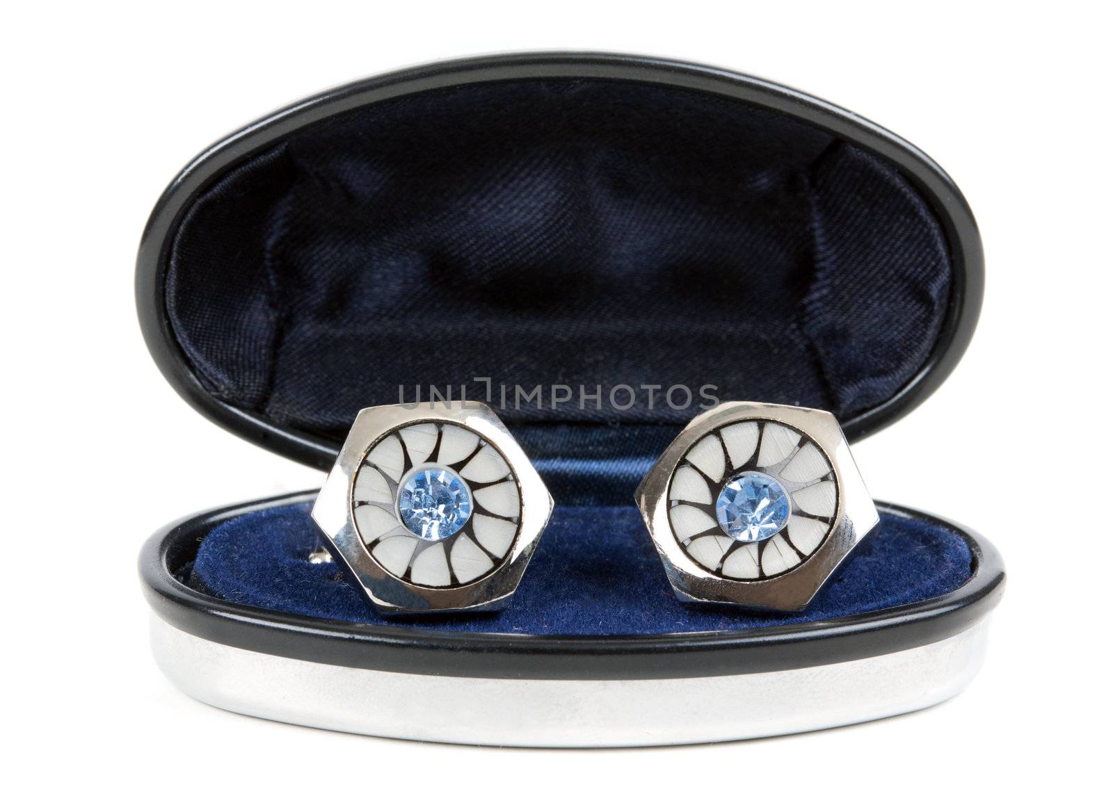 pair of platinum stud with topaz in an open casket isolated on white background