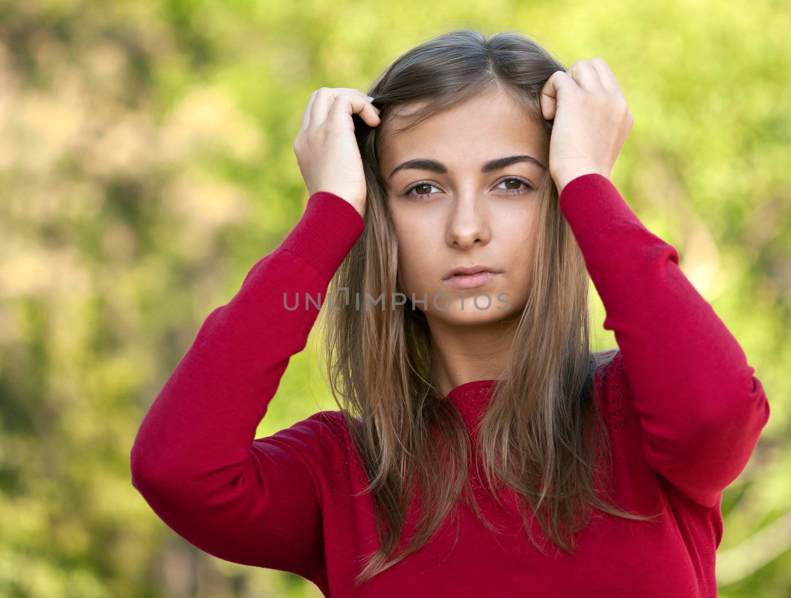 beautiful girl in a red jacket on a forest