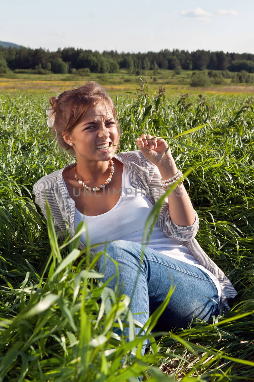 portrait of a beautiful girl in the green grass