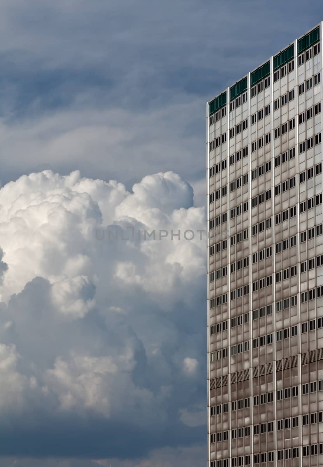 High building and bulk cumulus clouds in the sky