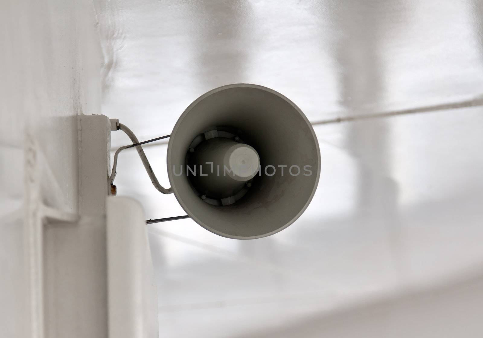 ship's megaphone on a white wall on the deck