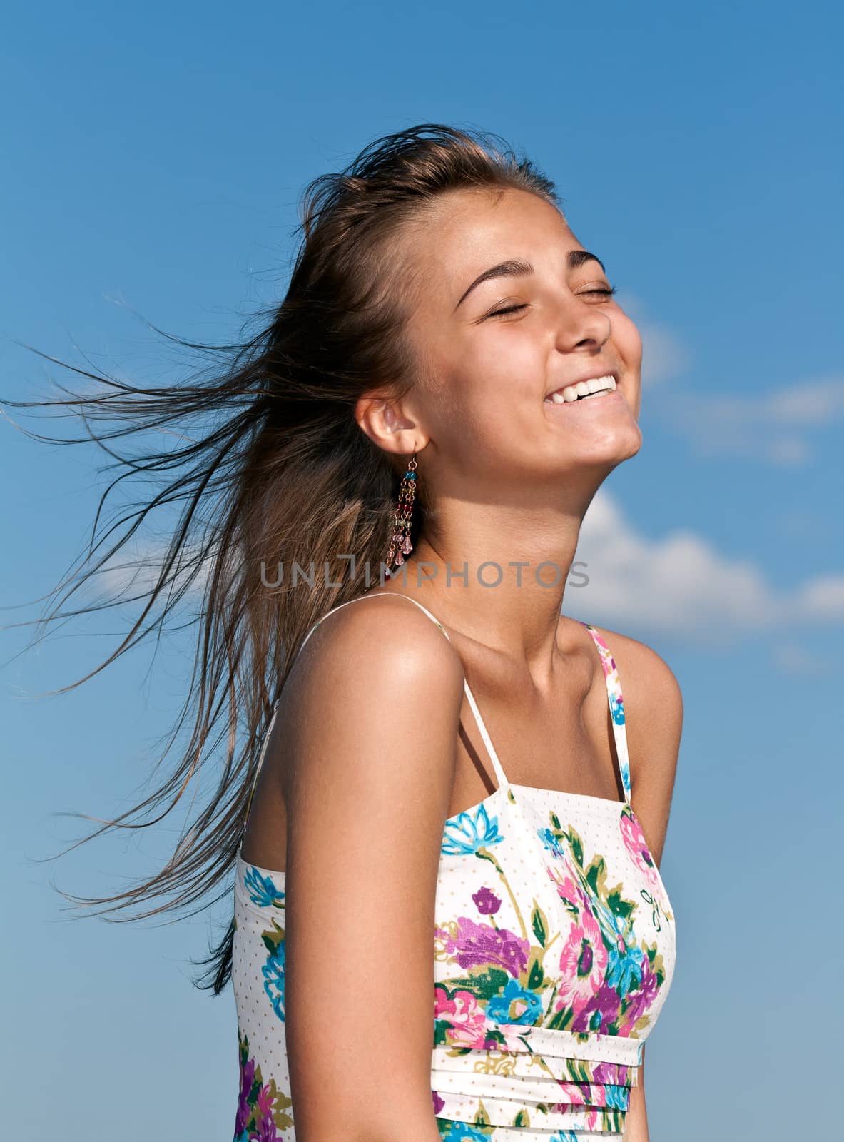beautiful young girl smiling in the sky