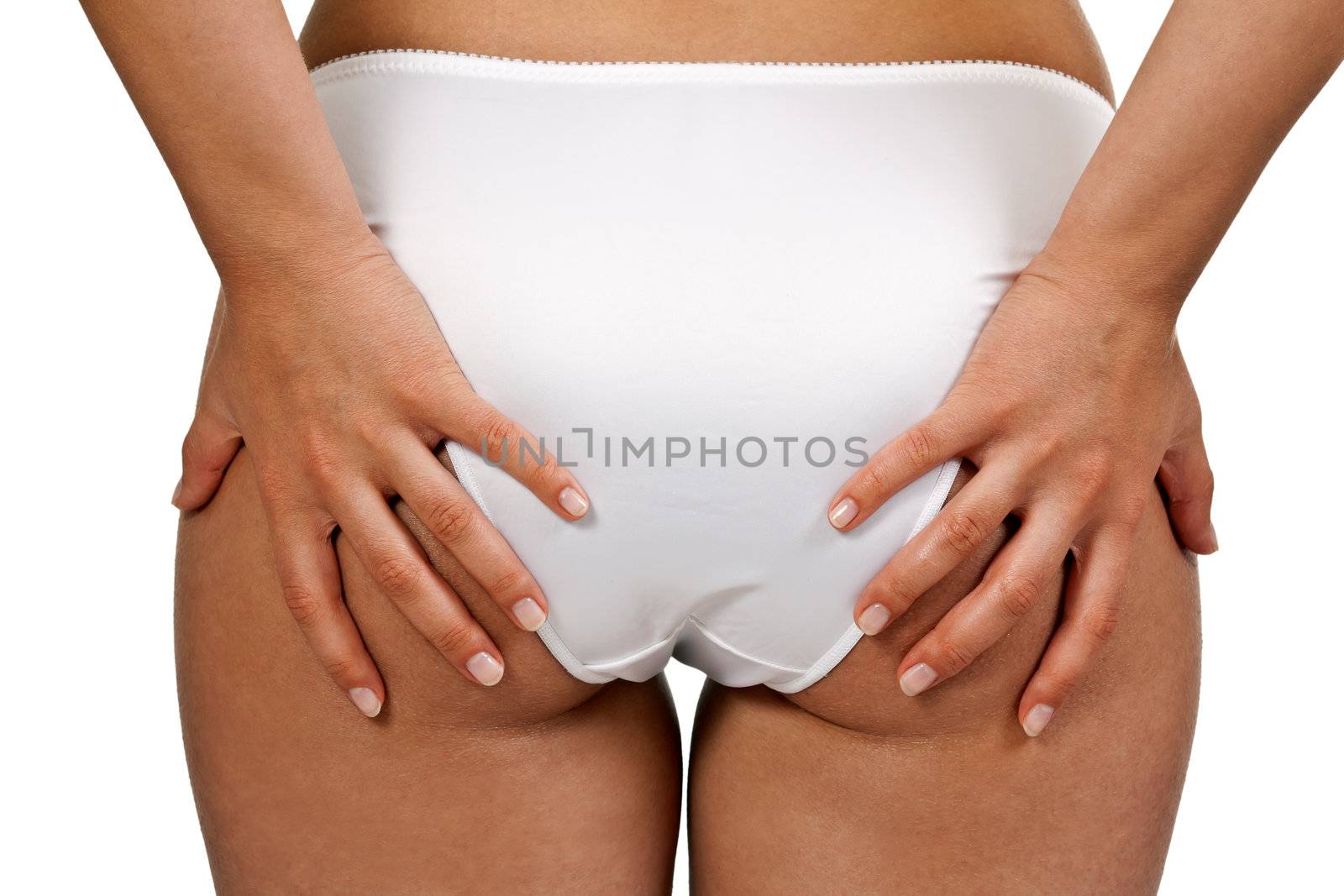 Beautiful women's buttocks in white shorts with his hands with a manicure